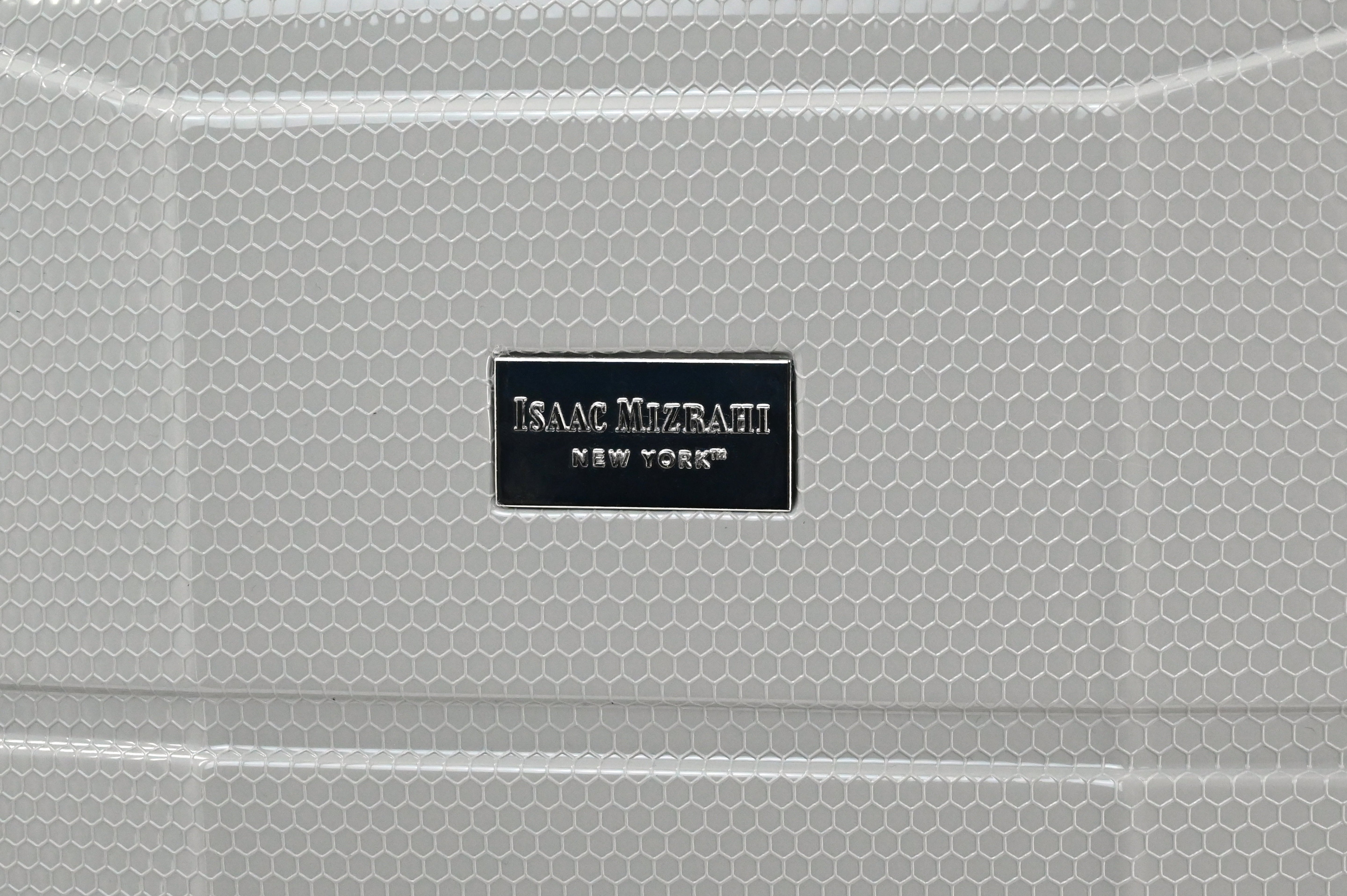 Close-up of a textured surface with 'Isaac Mizrahi New York' logo.