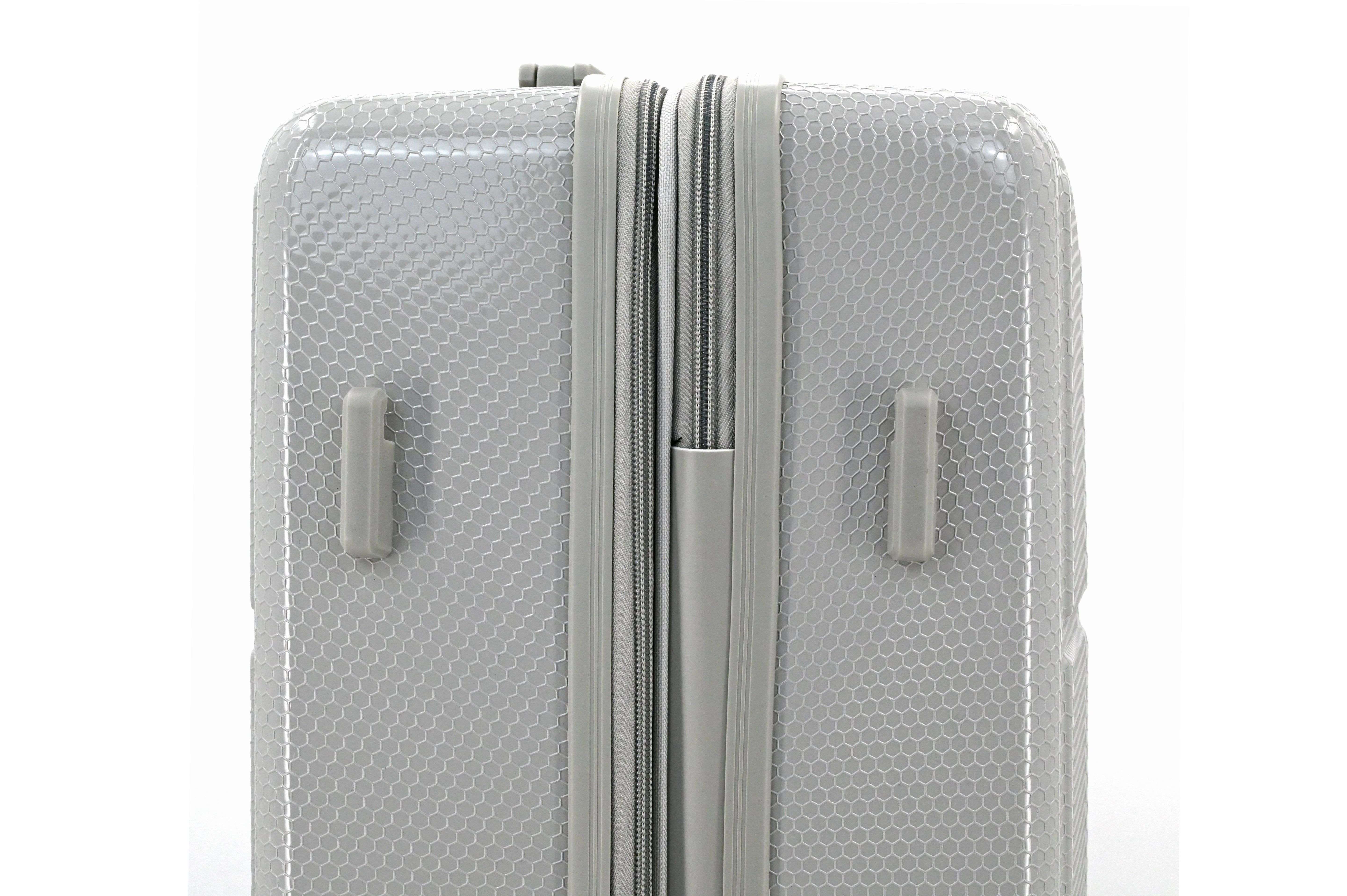 Silver suitcase with a textured surface on a white background