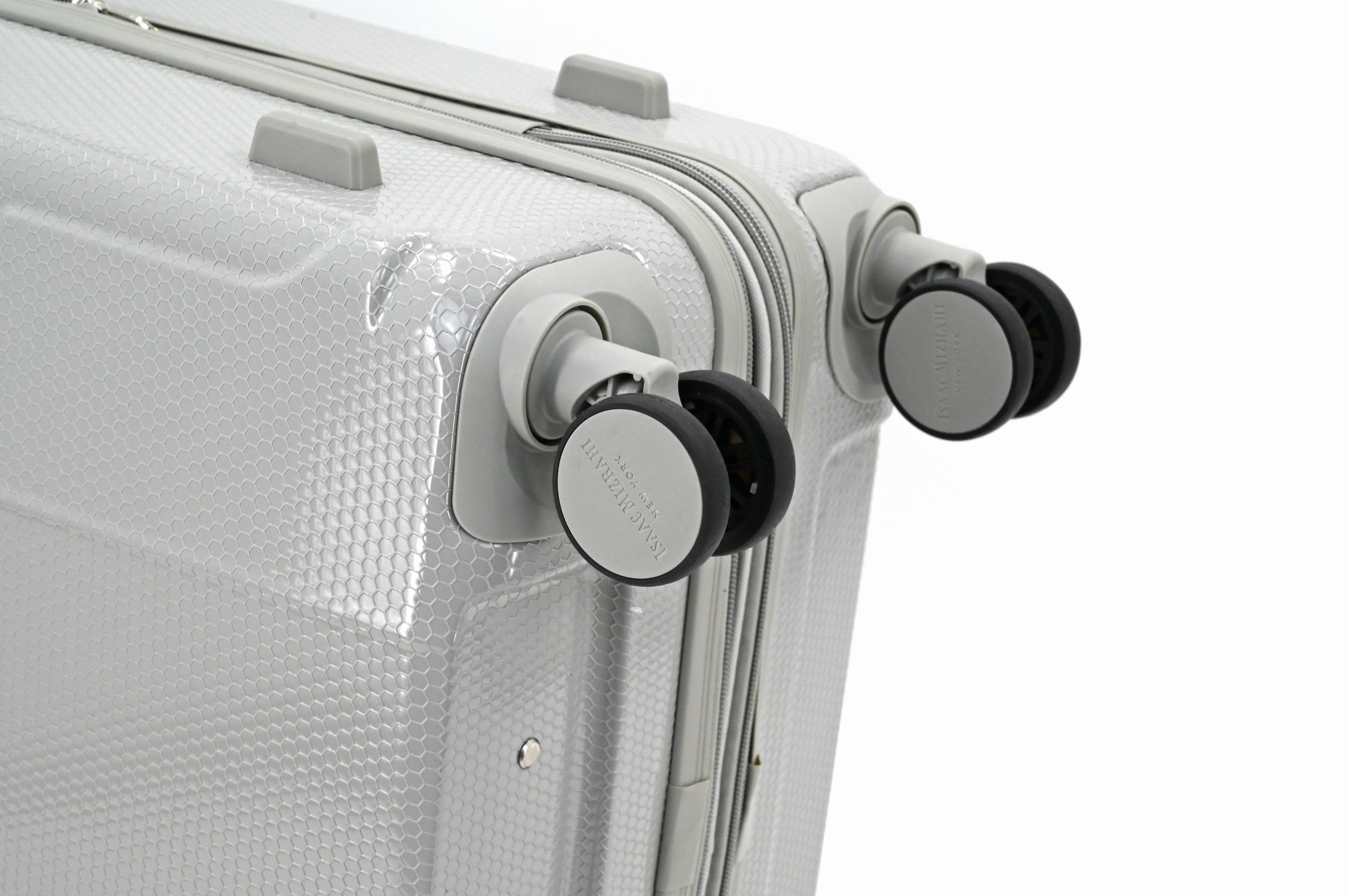 Close-up of a silver suitcase with wheels on a white background