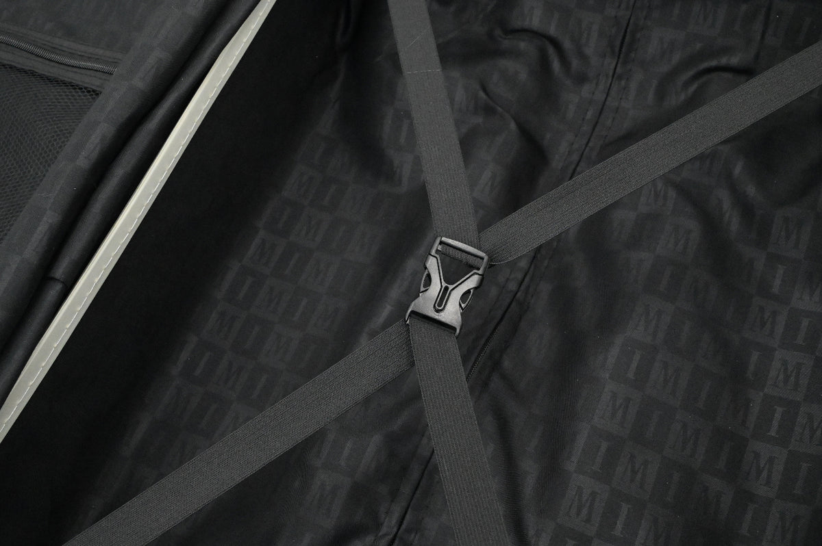 Close-up of a black suitcase with a patterned texture and a visible brand logo.