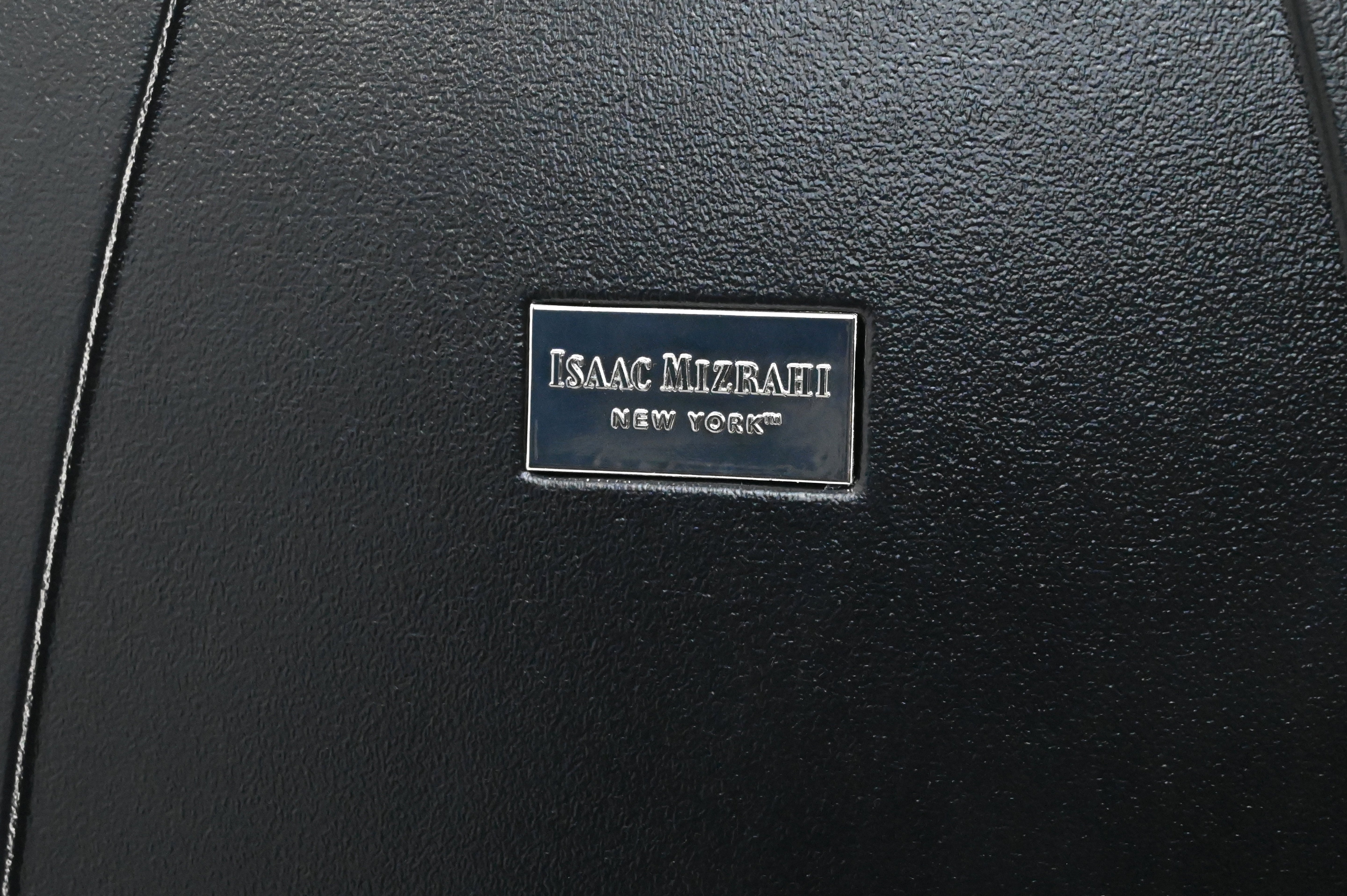 Black leather surface with Isaac Mizrahi New York label