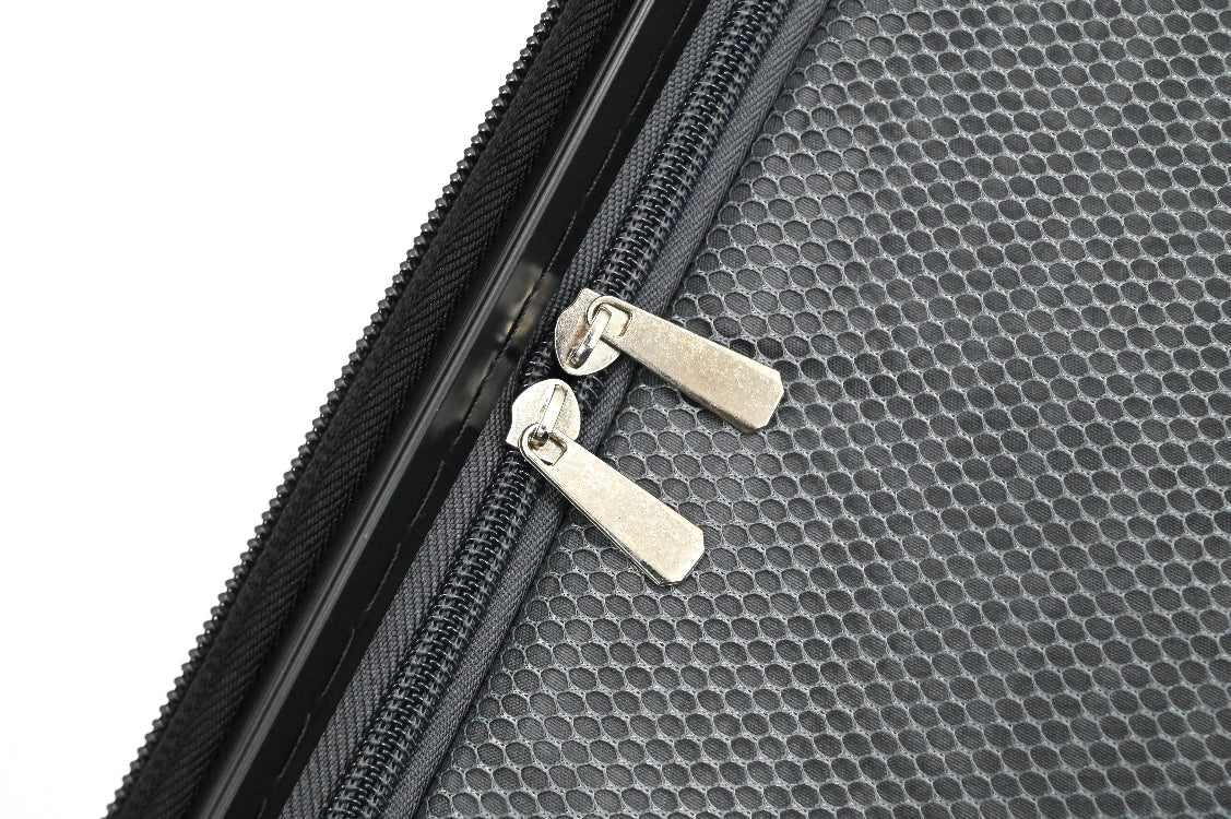 Close-up of a textured black surface with a zipper and metallic pull.