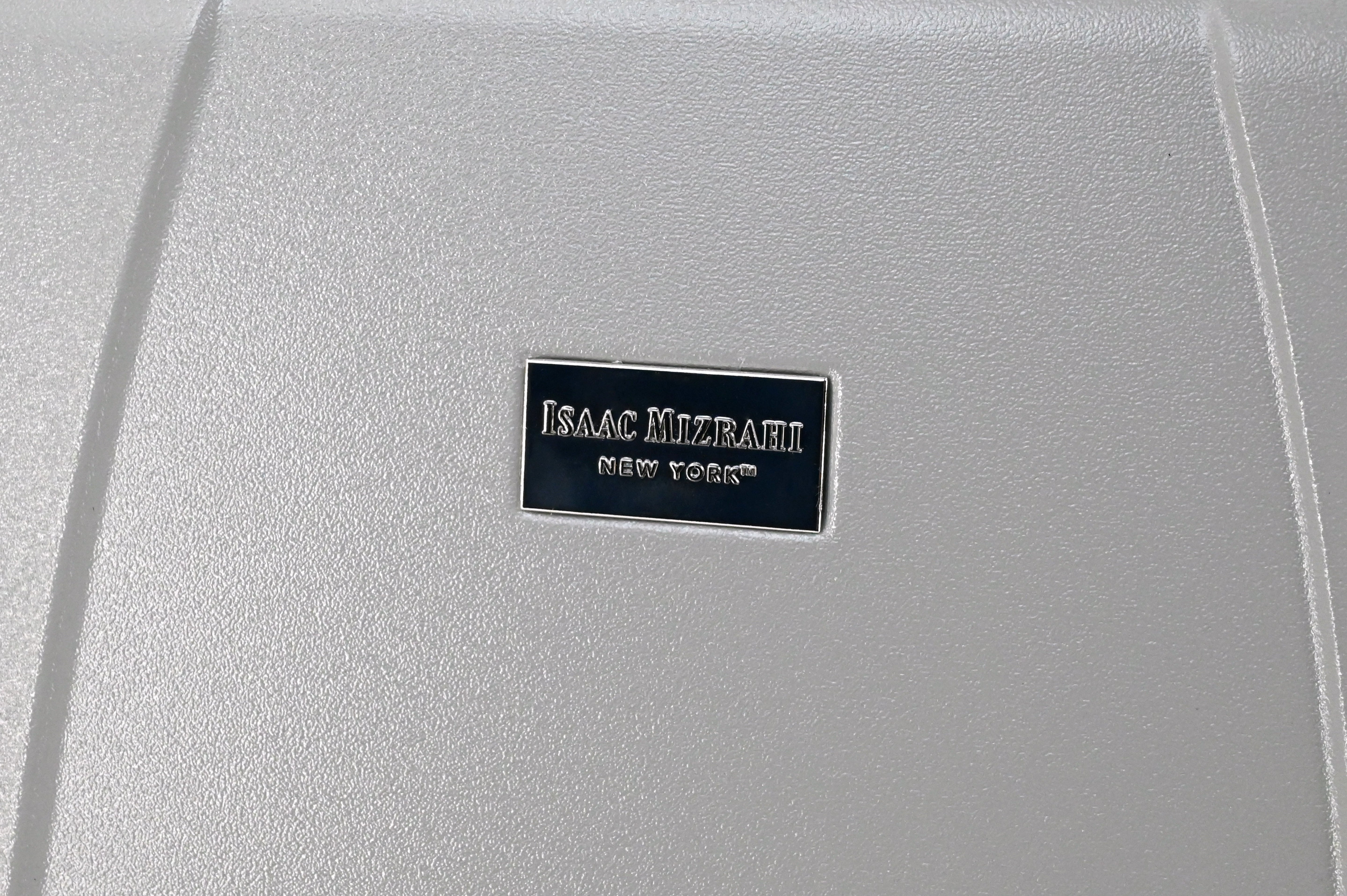 Silver textured surface with a visible Isaac Mizrahi New York label.