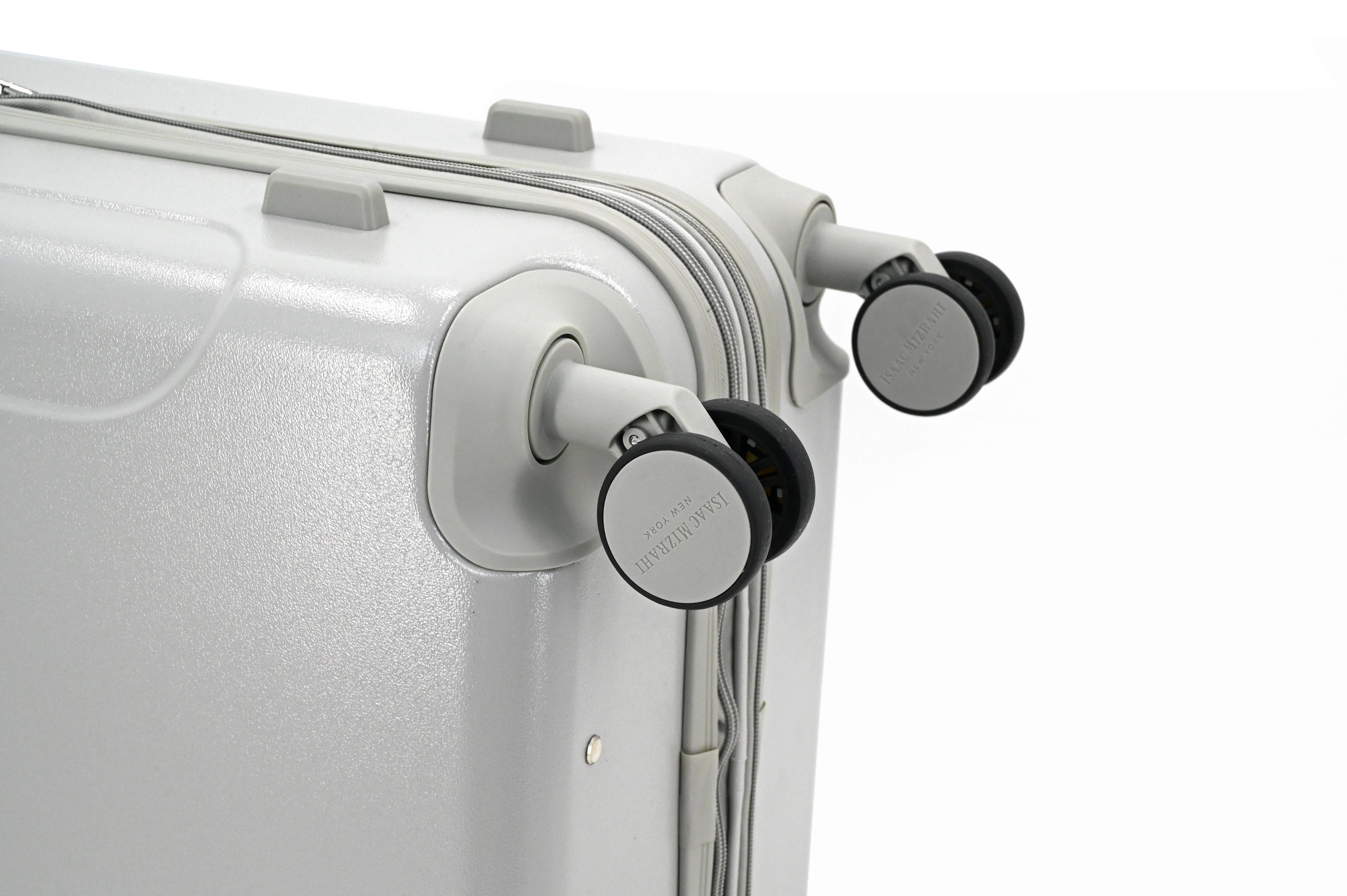 Close-up of a silver suitcase with black wheels on a white background