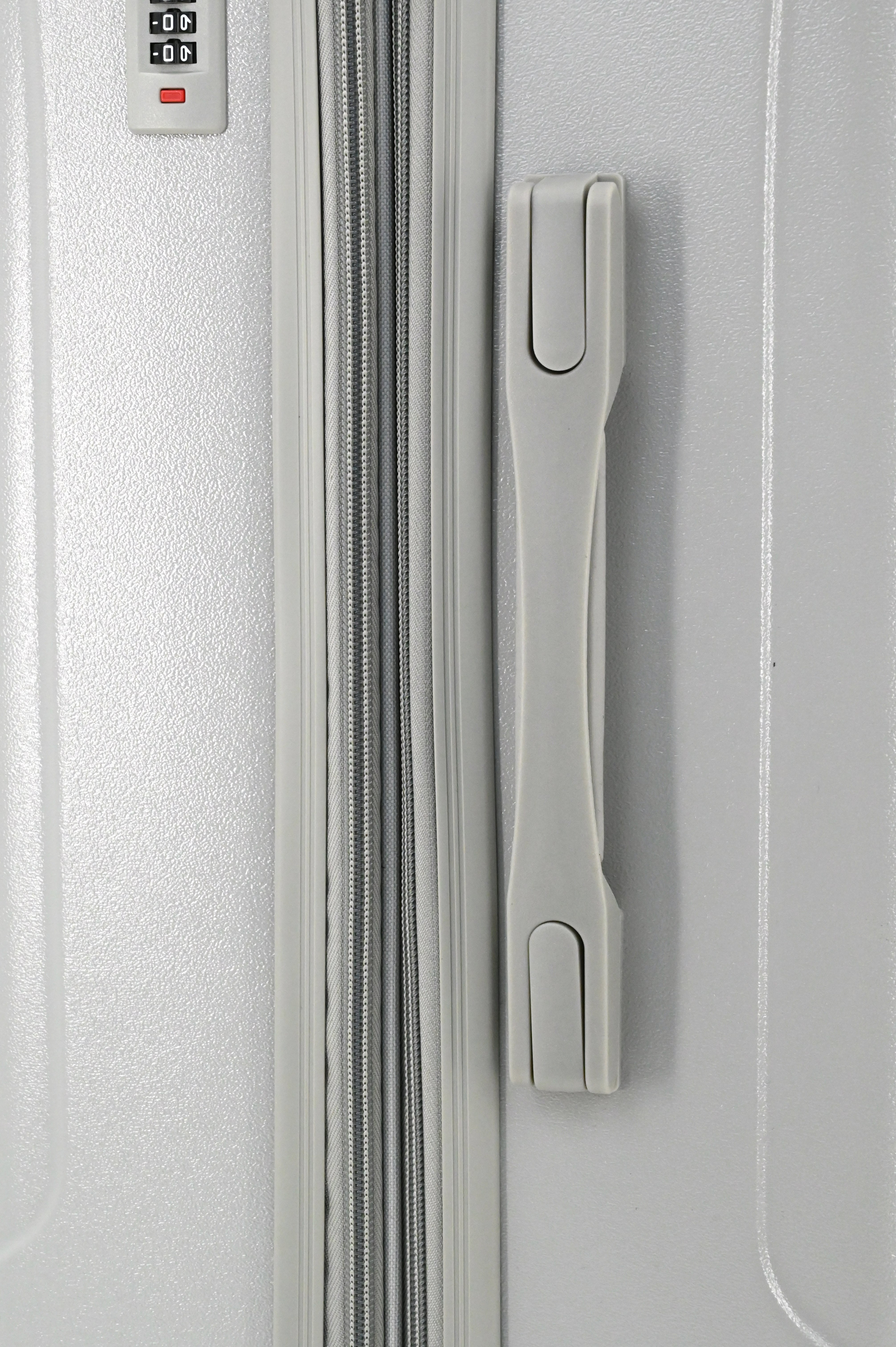 Close-up of a silver suitcase with a handle and lock mechanism.