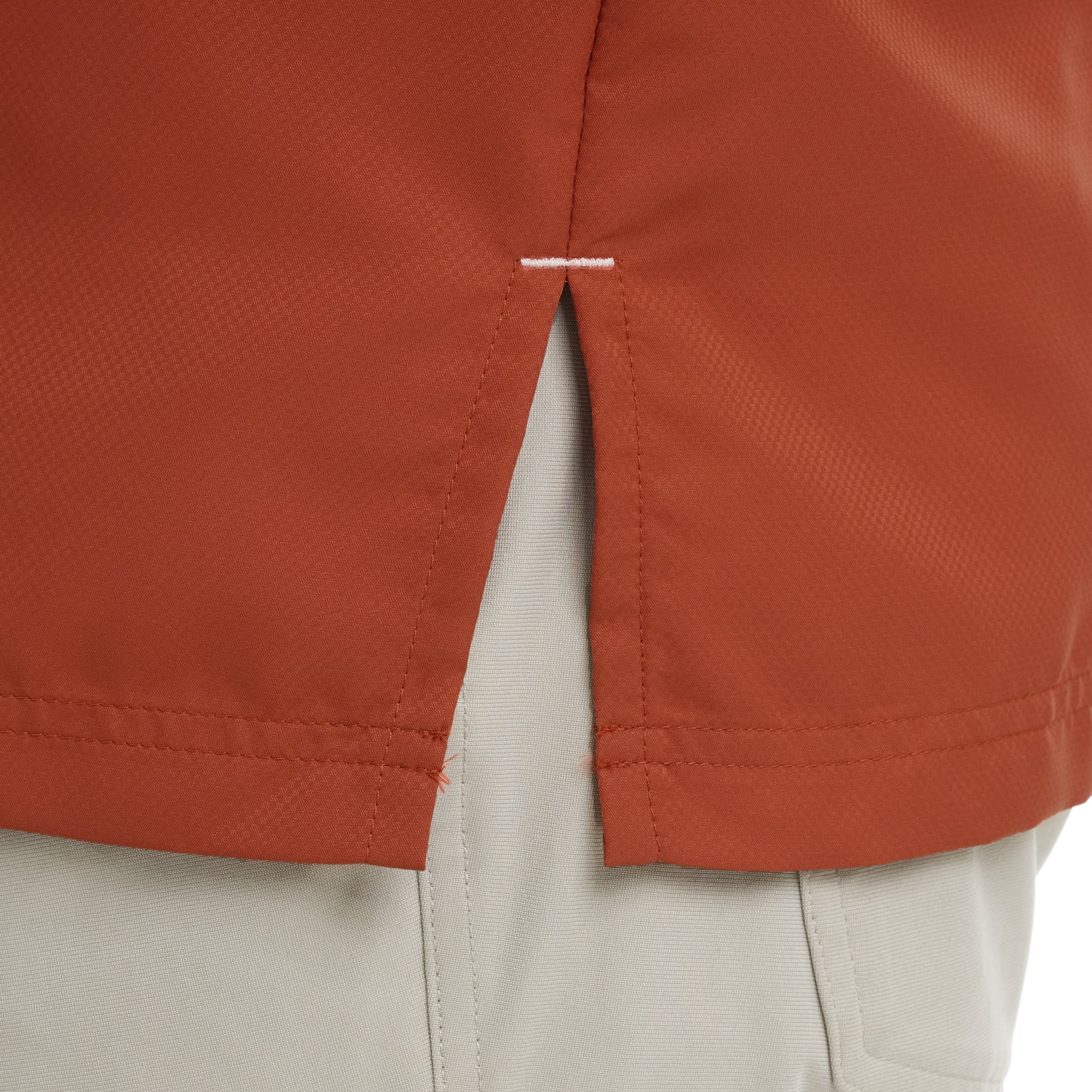 Close-up of a red jacket with beige lining on a white background