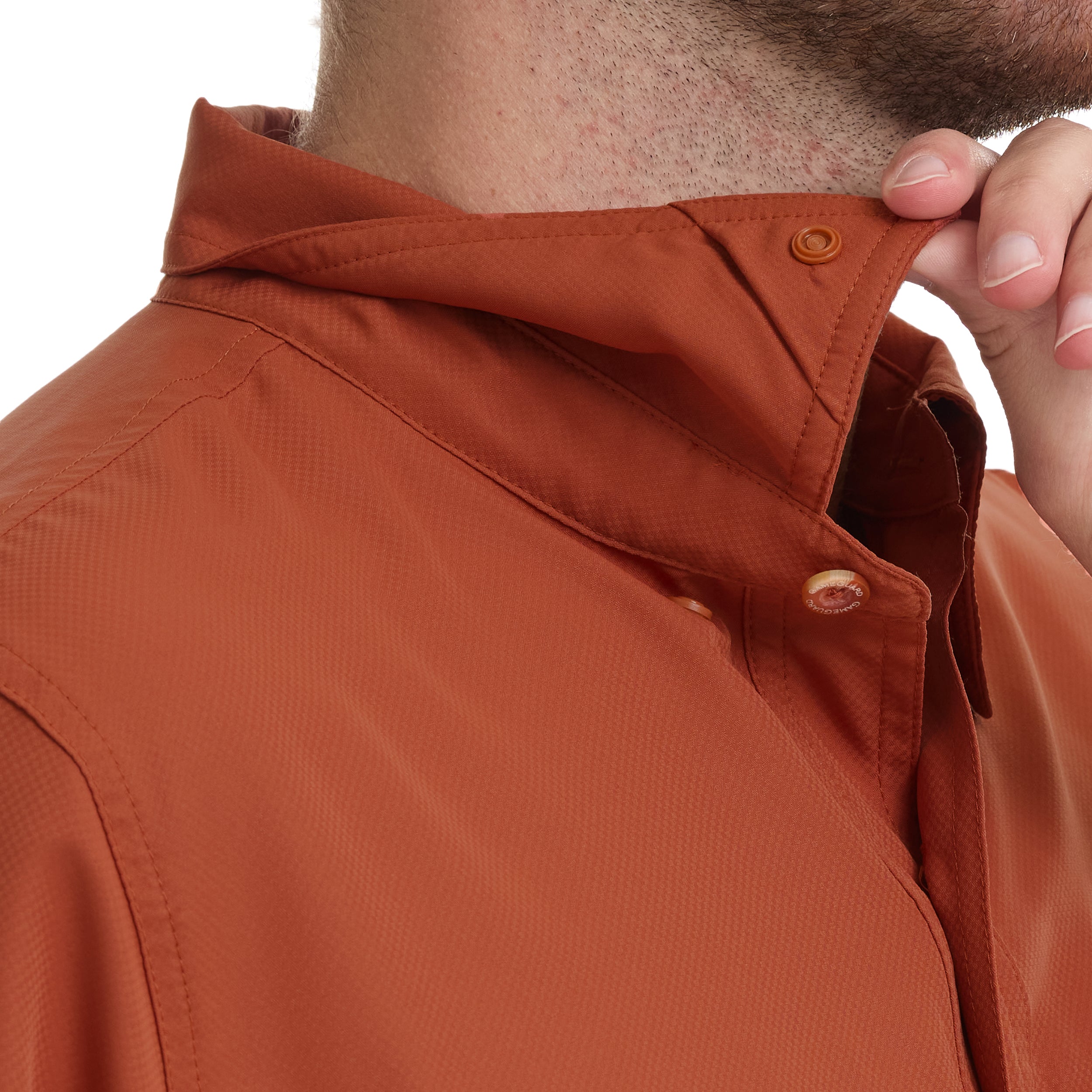 Close-up of a person wearing an orange jacket with a buttoned collar.