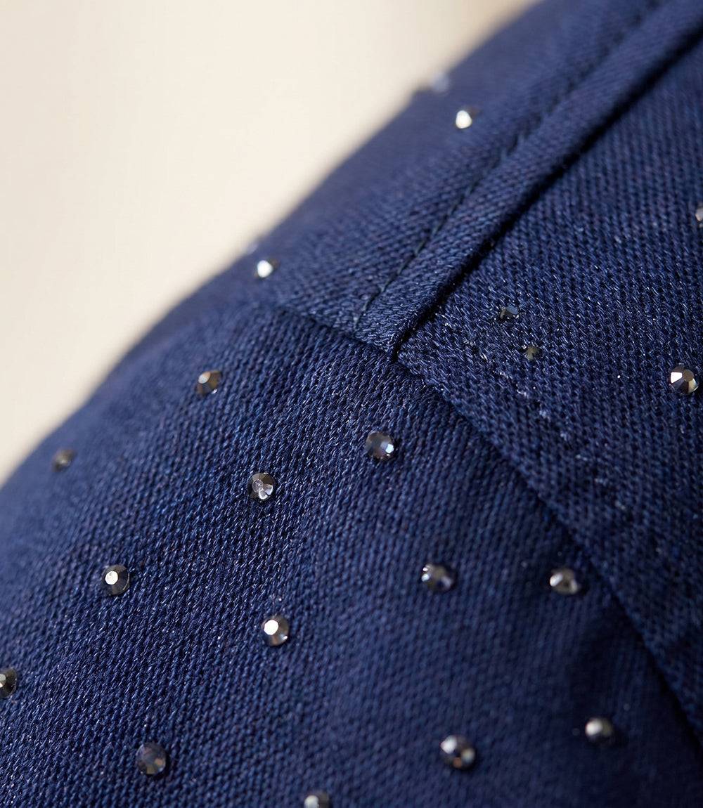Navy blue fabric with small silver embellishments on a neutral background