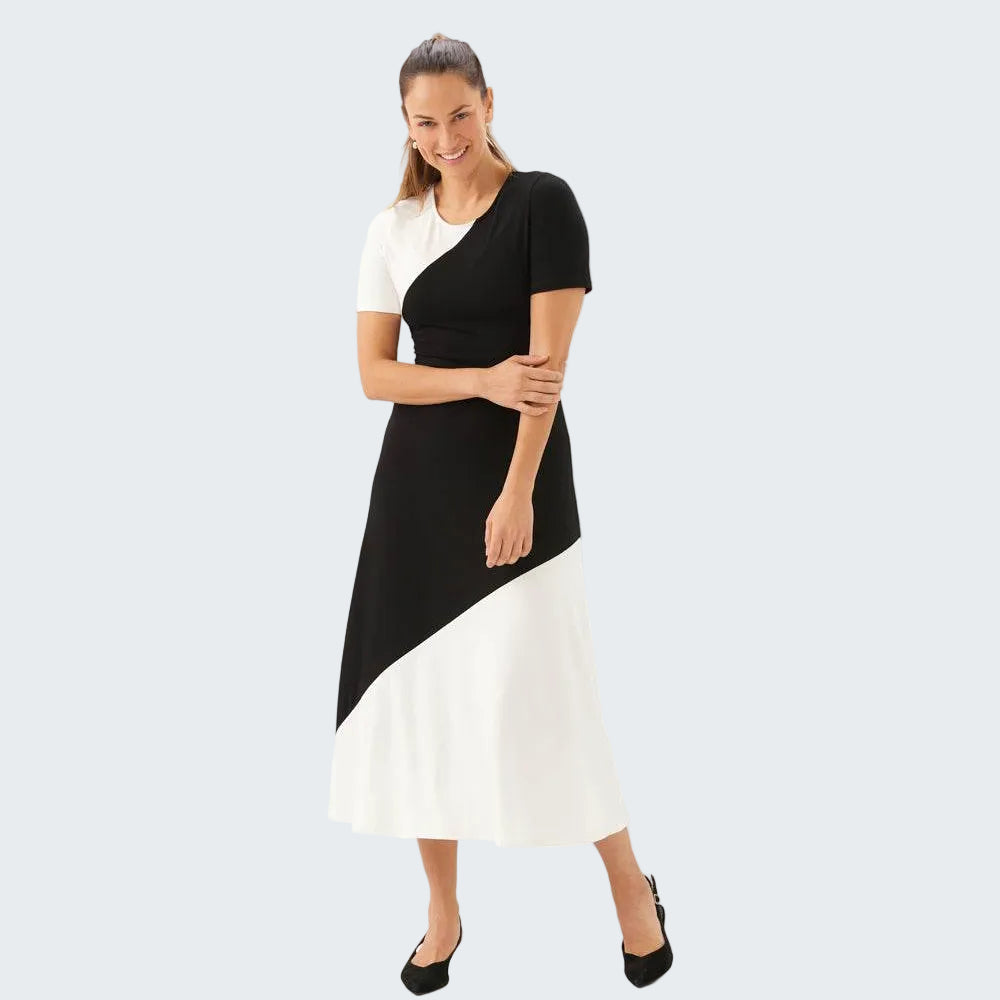 Woman wearing a black and white dress on a white background