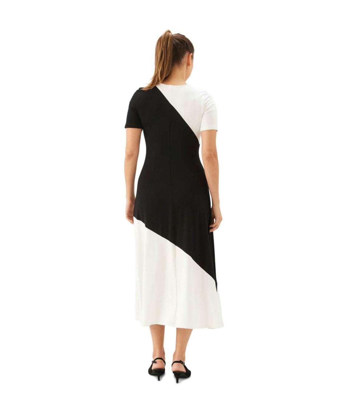 Woman wearing a black and white dress on a white background