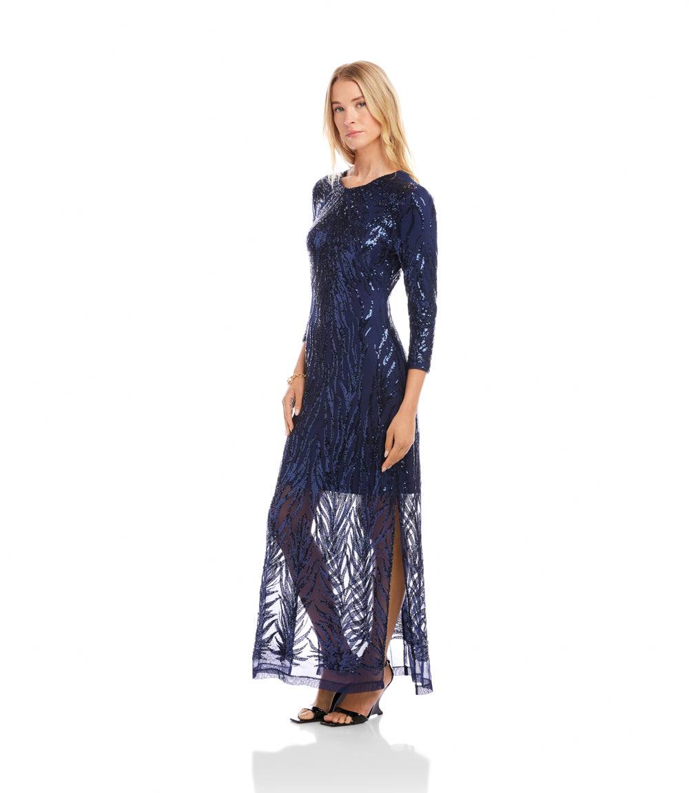 Woman wearing a navy blue dress with a pattern on a white background