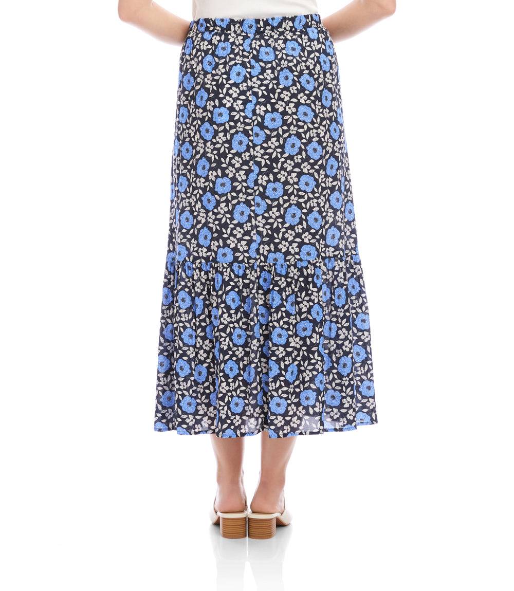 Person wearing a blue floral skirt on a white background
