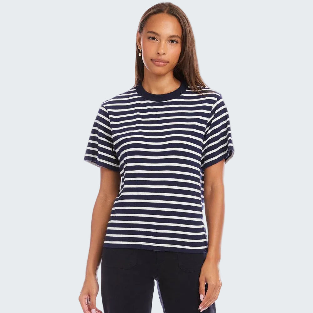 Woman wearing a navy and white striped t-shirt on a white background