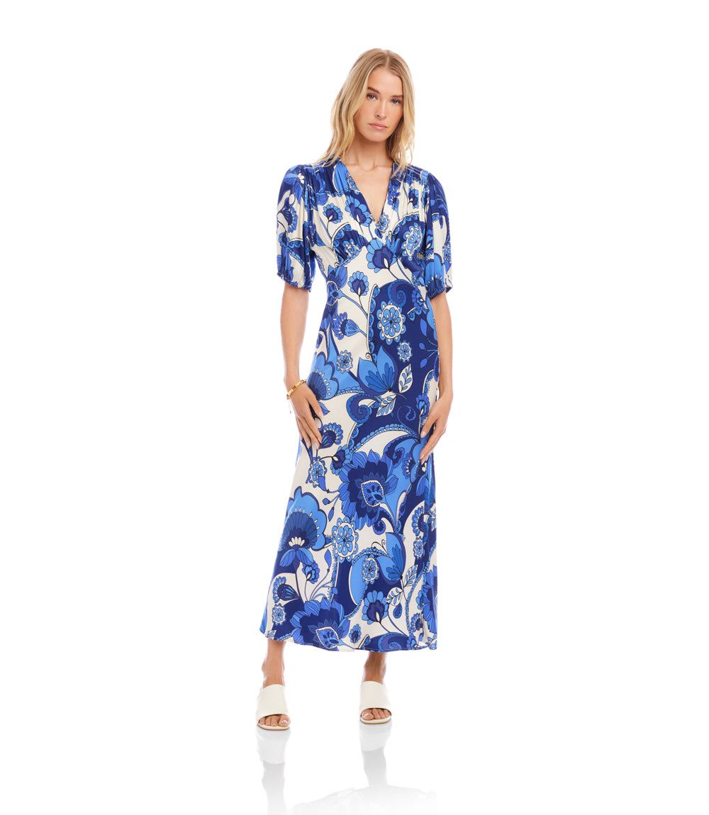 Woman wearing a blue floral dress on a white background