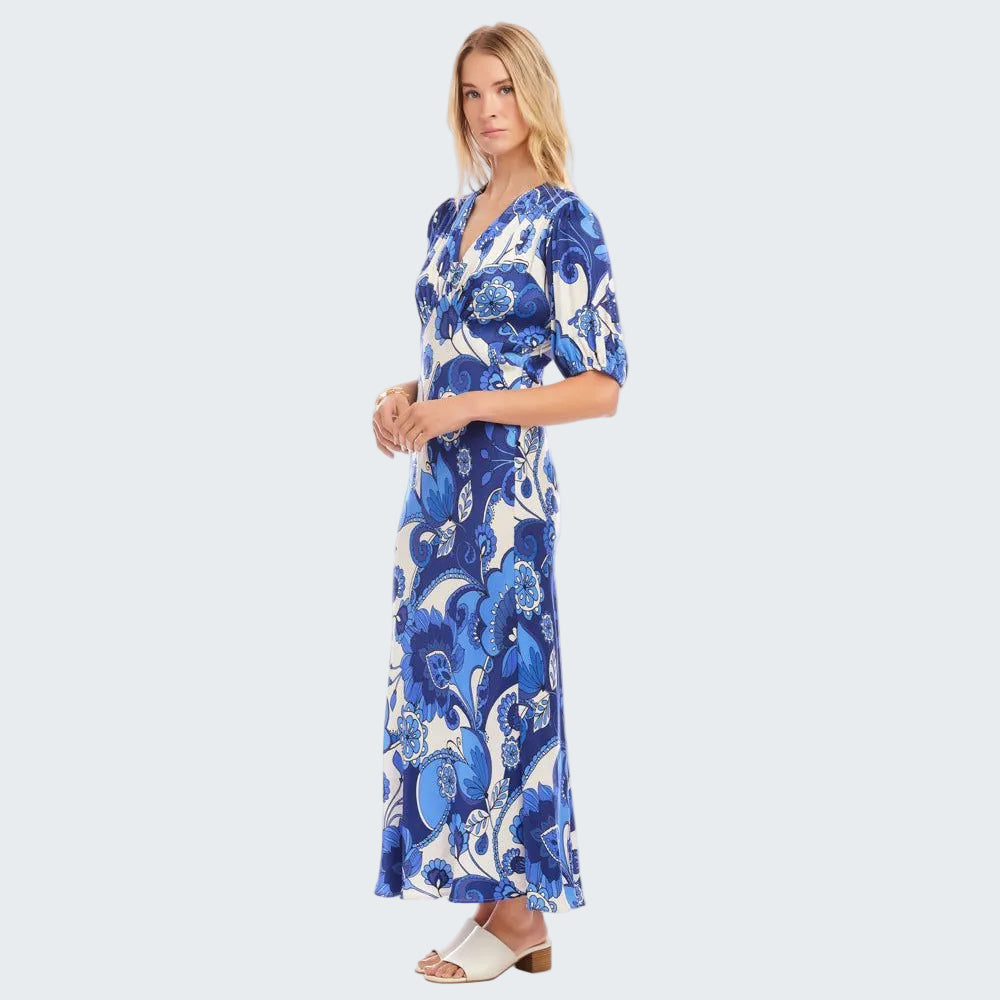 Woman wearing a blue floral dress on a white background