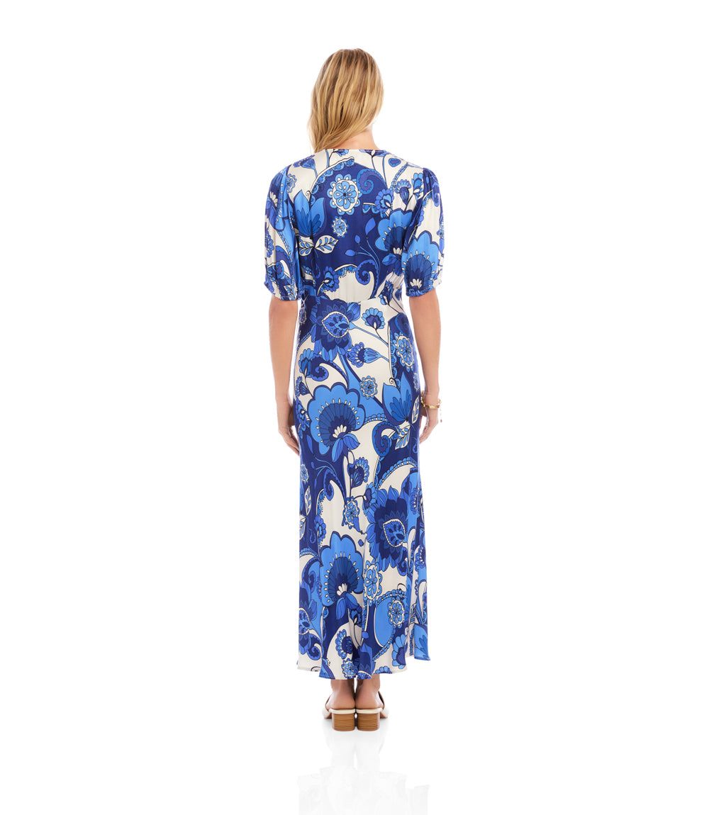 Woman wearing a blue floral dress on a white background
