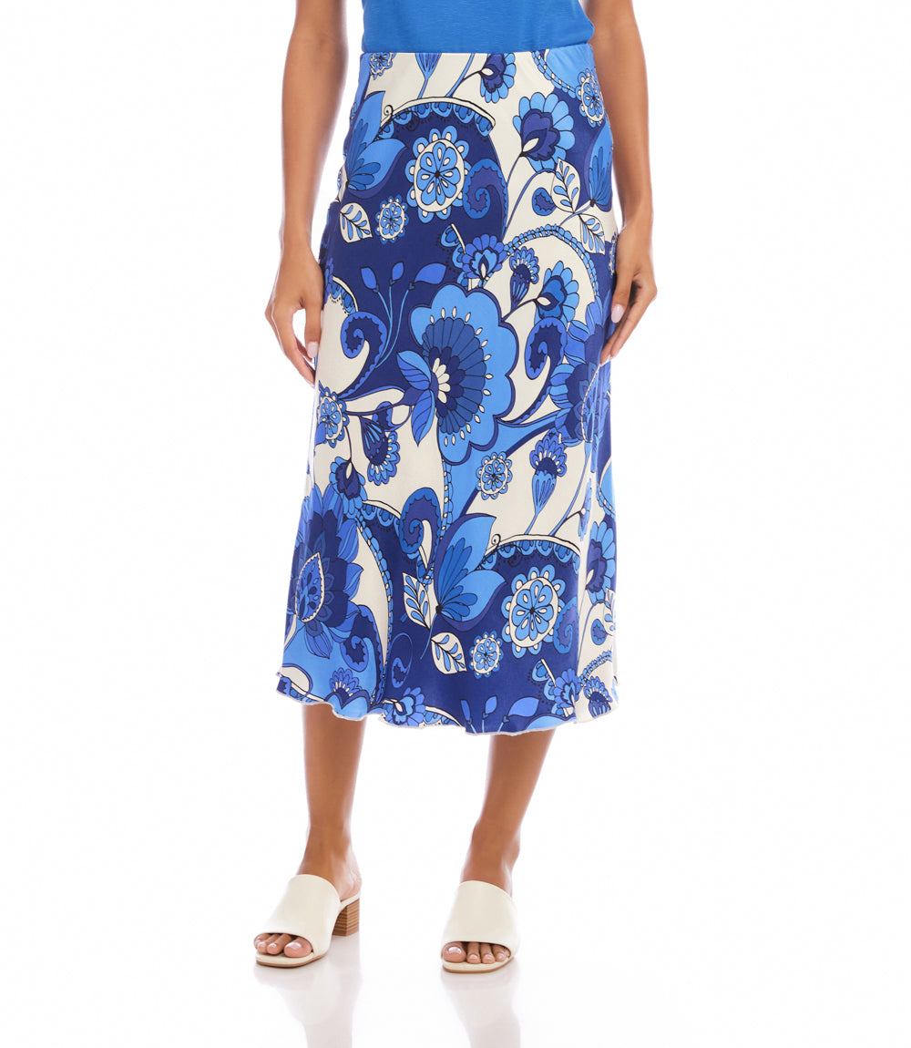 Woman wearing a blue and white floral patterned skirt on a white background
