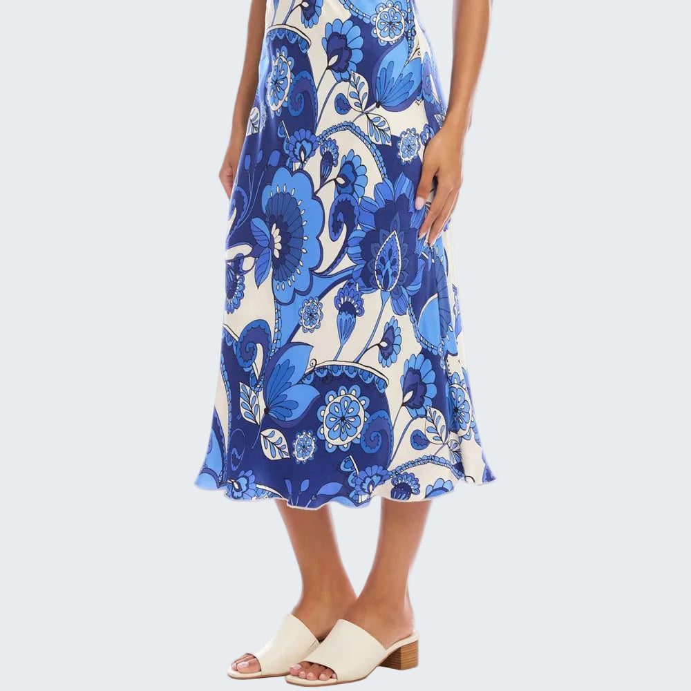 Woman wearing a blue and white floral skirt on a white background