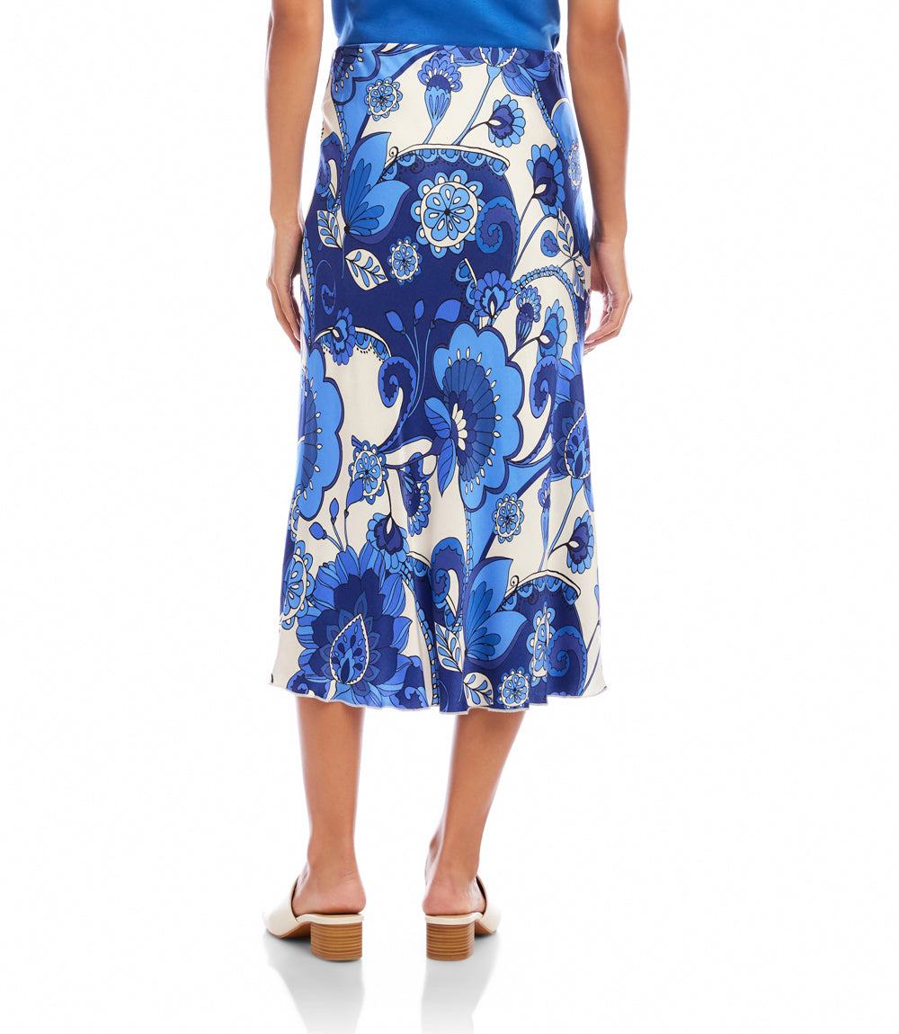 Woman wearing a blue and white floral patterned skirt on a white background
