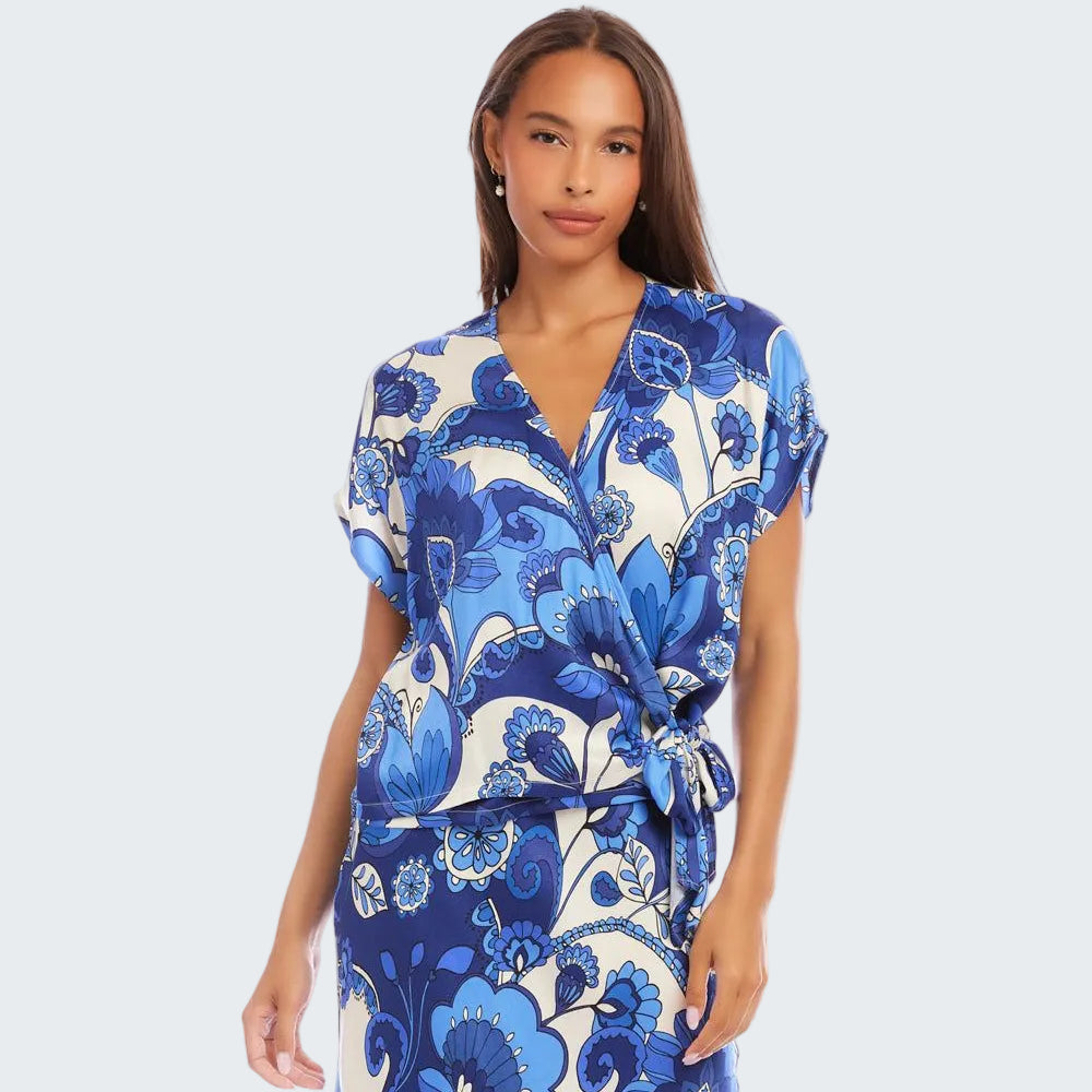 Woman wearing a blue and white floral dress on a white background