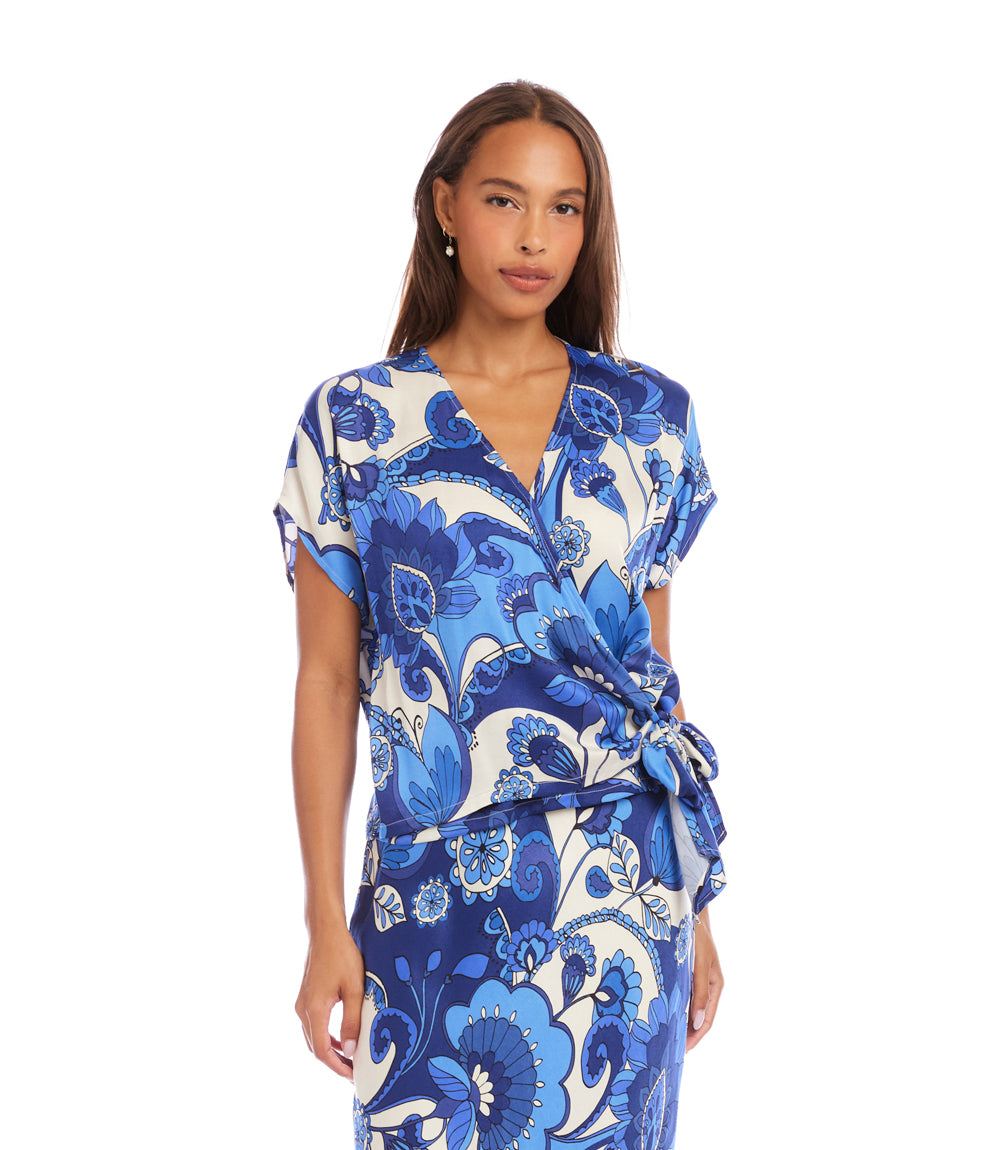 Woman wearing a blue and white floral dress on a white background