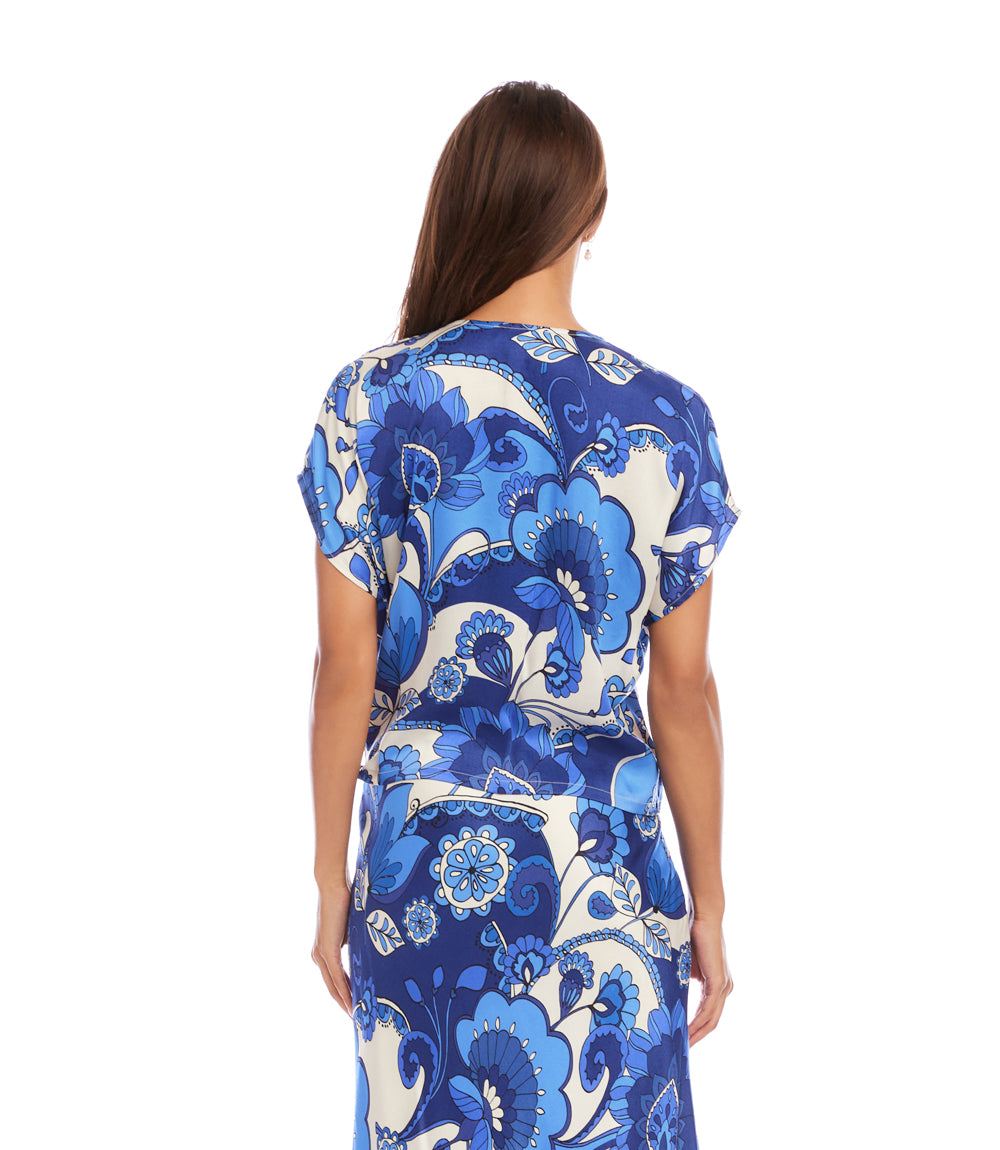 Woman wearing a blue and white floral dress on a white background