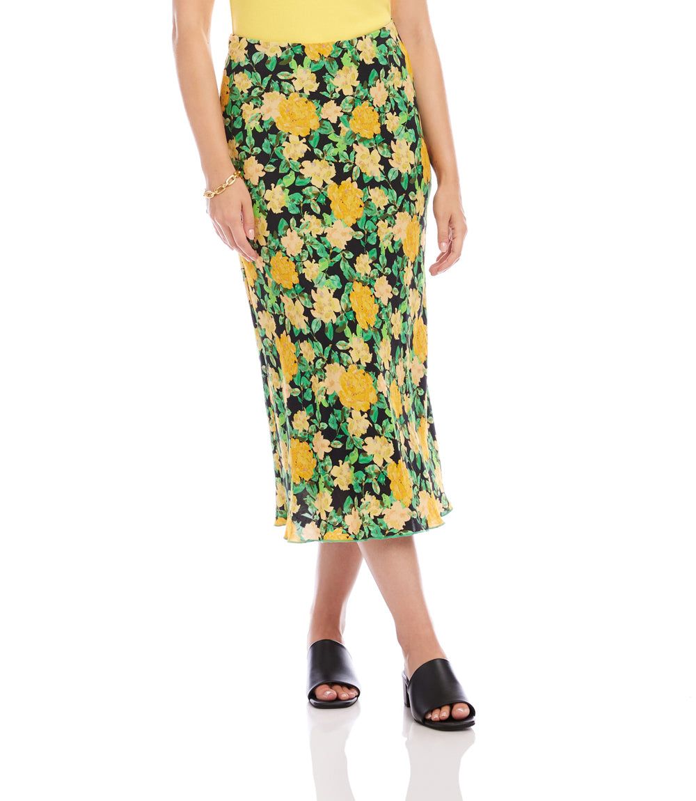 Woman wearing a floral skirt with yellow flowers on a green background