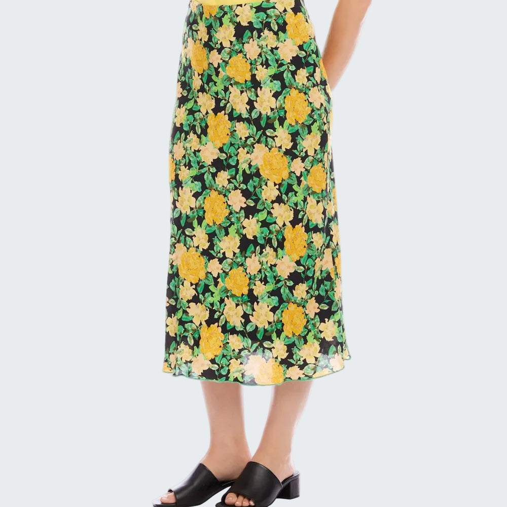Floral skirt with yellow flowers on a black background worn by a person.