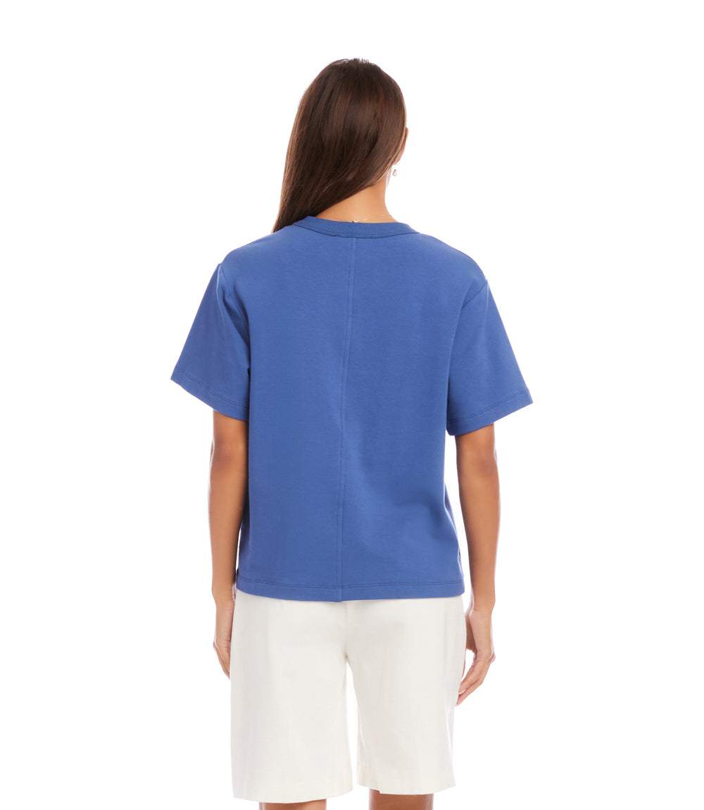 Person wearing a blue t-shirt and white shorts on a white background