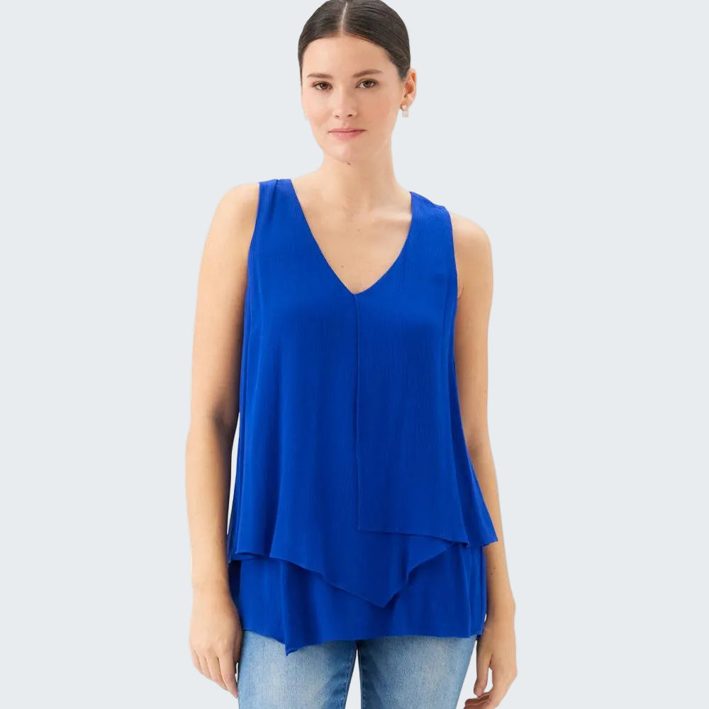 Woman wearing a blue sleeveless top on a white background