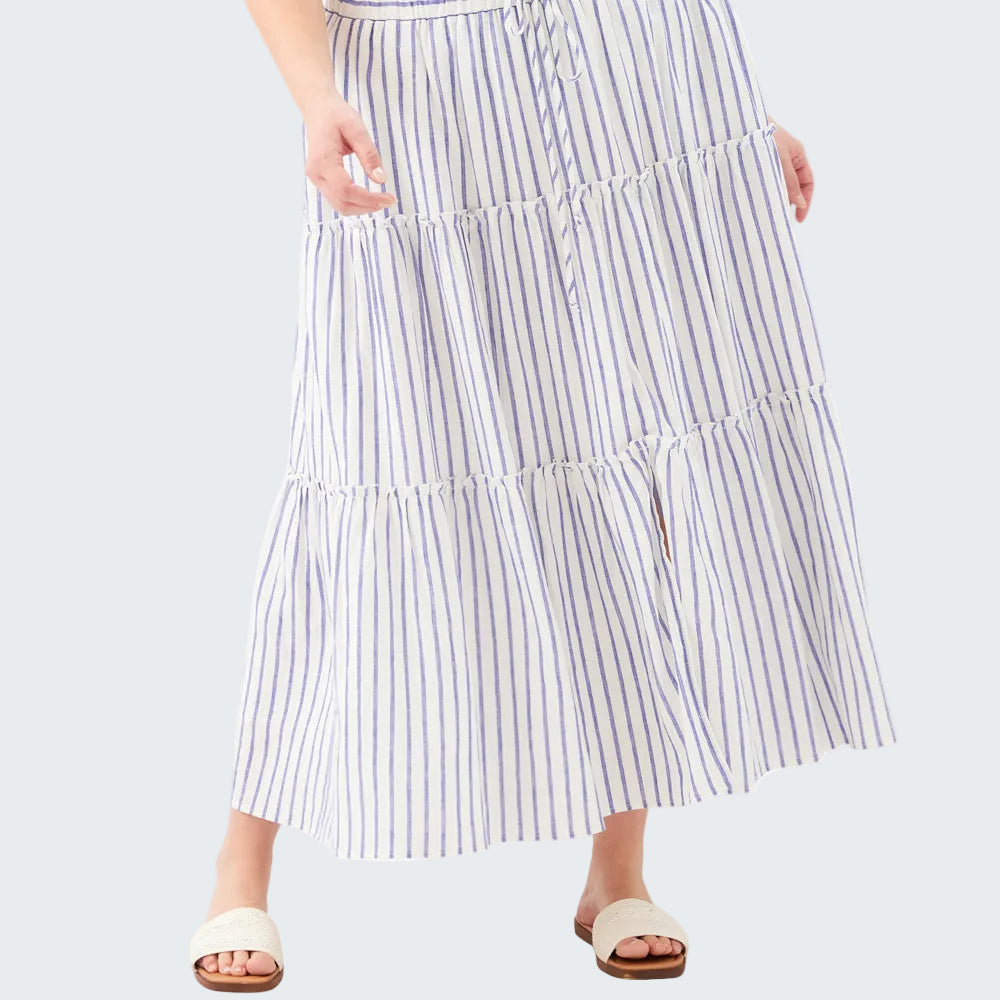 Woman wearing a long, tiered striped skirt on a white background