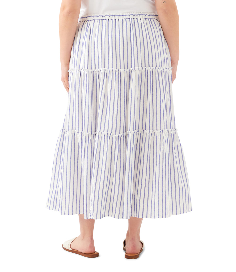 Person wearing a tiered striped skirt on a white background