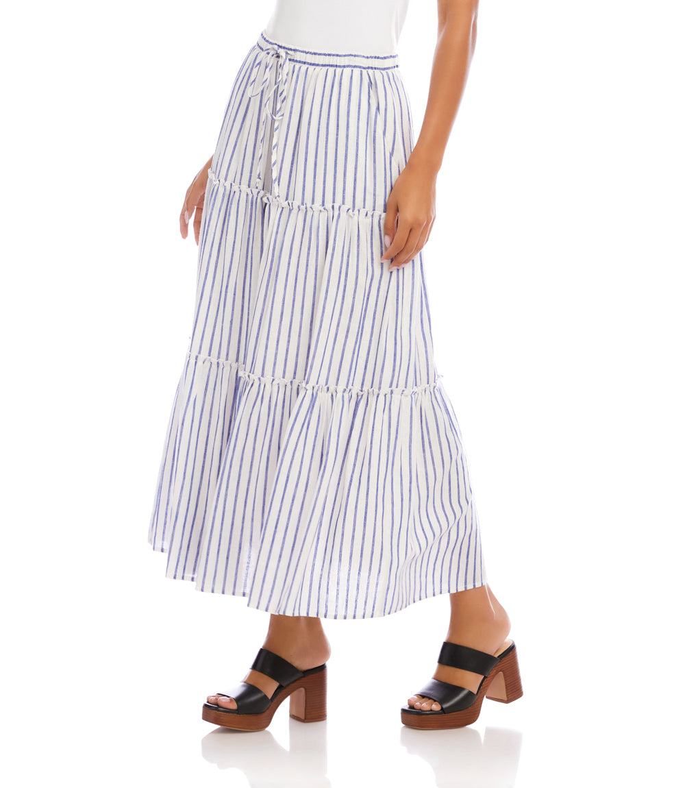 Woman wearing a blue and white striped skirt on a white background