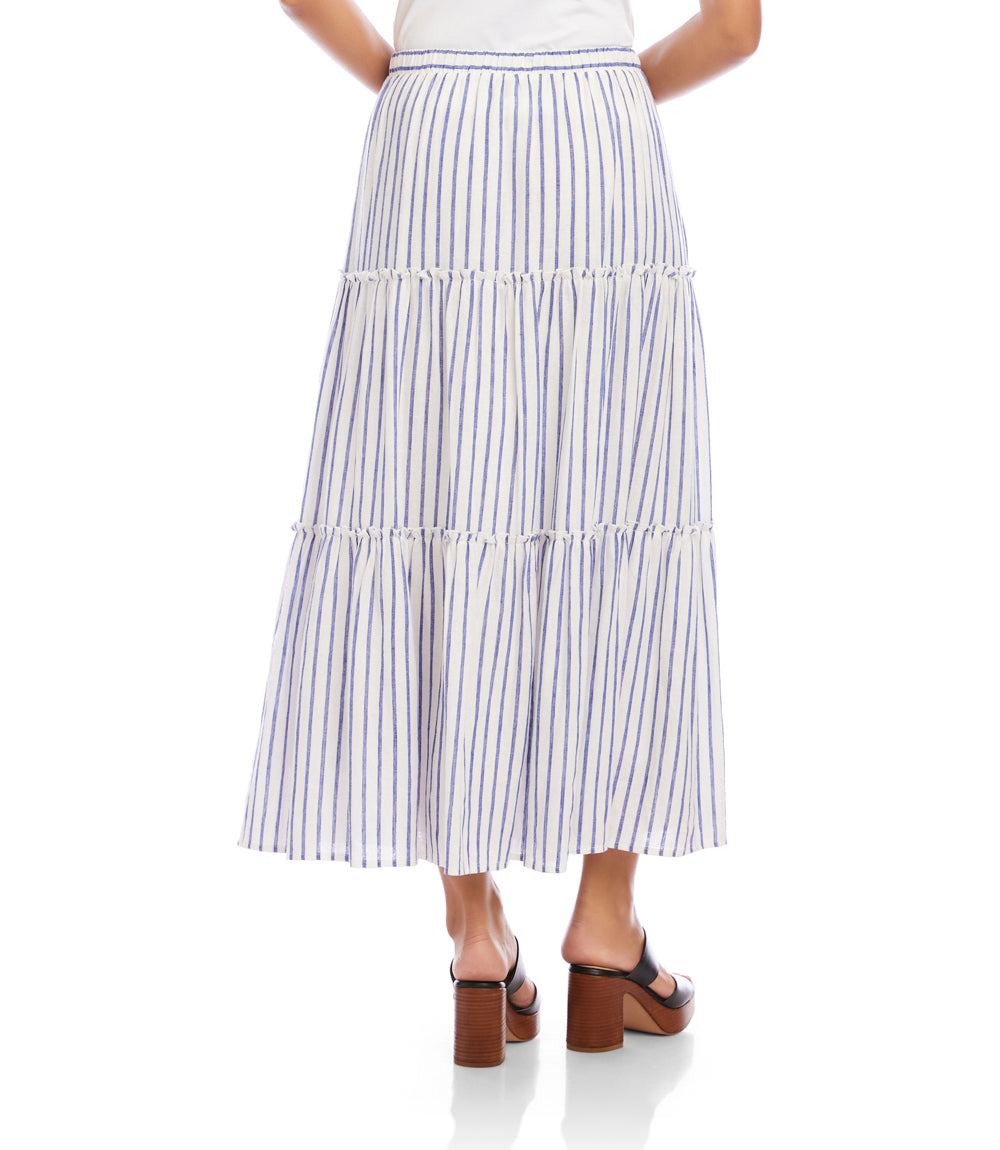 Woman wearing a tiered striped skirt on a white background