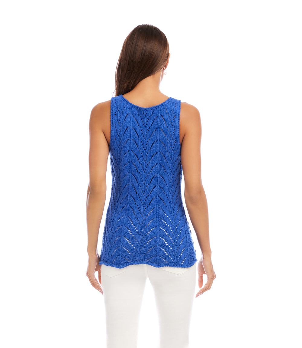 Woman wearing a blue sleeveless knitted top on a white background