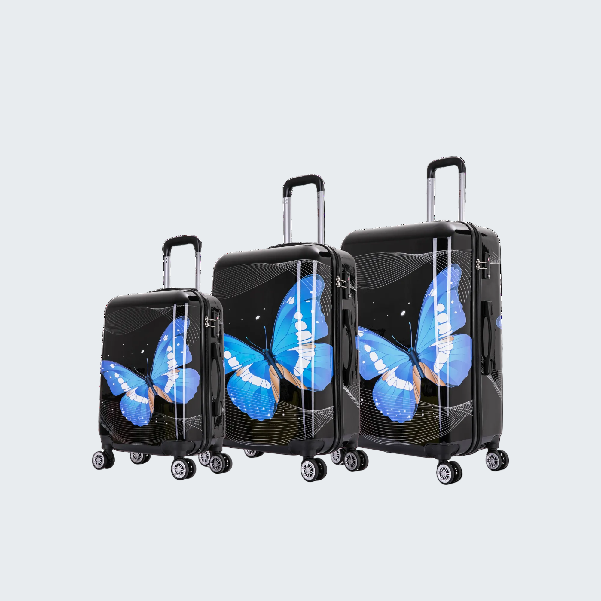 Set of three black suitcases with blue butterfly designs on a white background