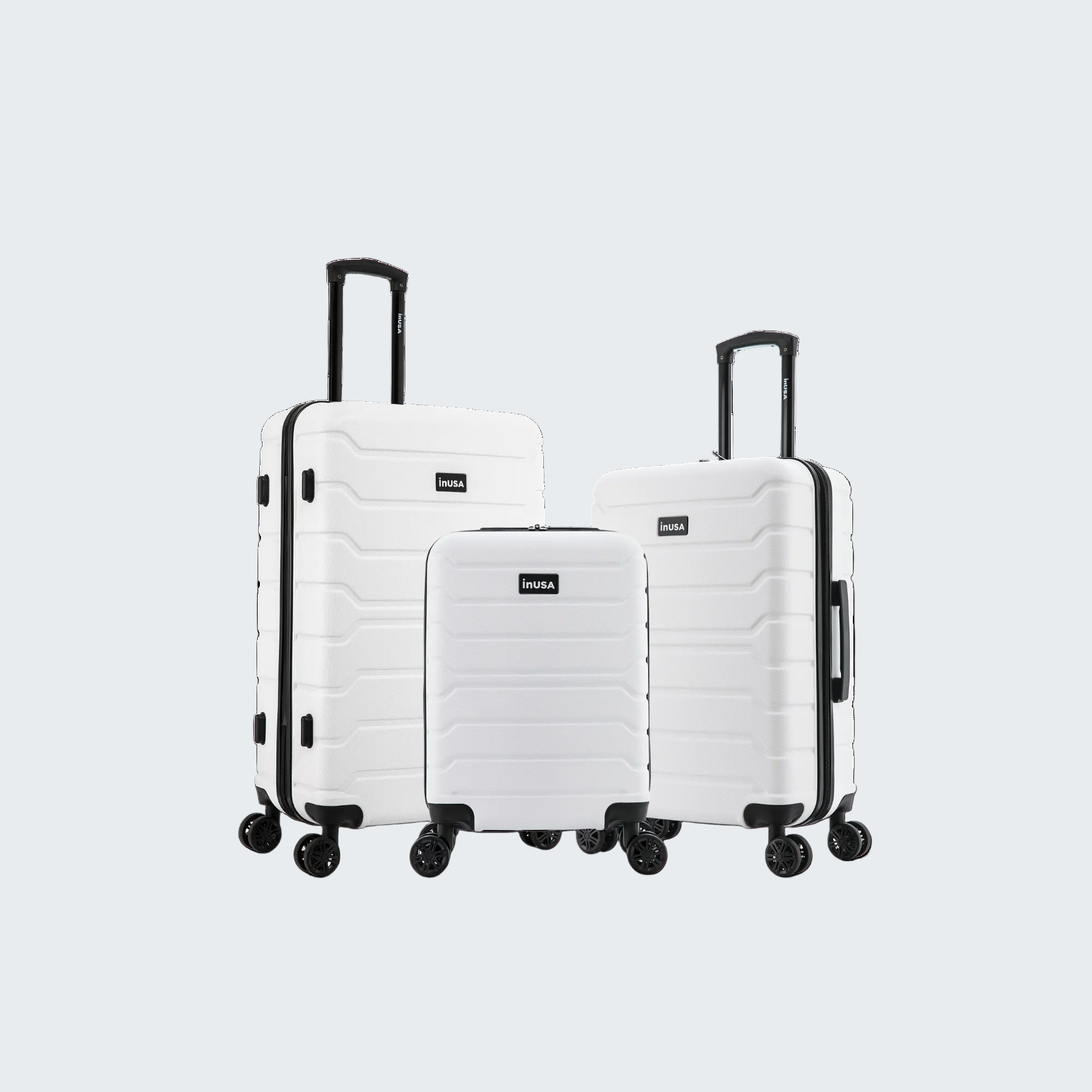 Set of three white suitcases with black handles and wheels on a white background