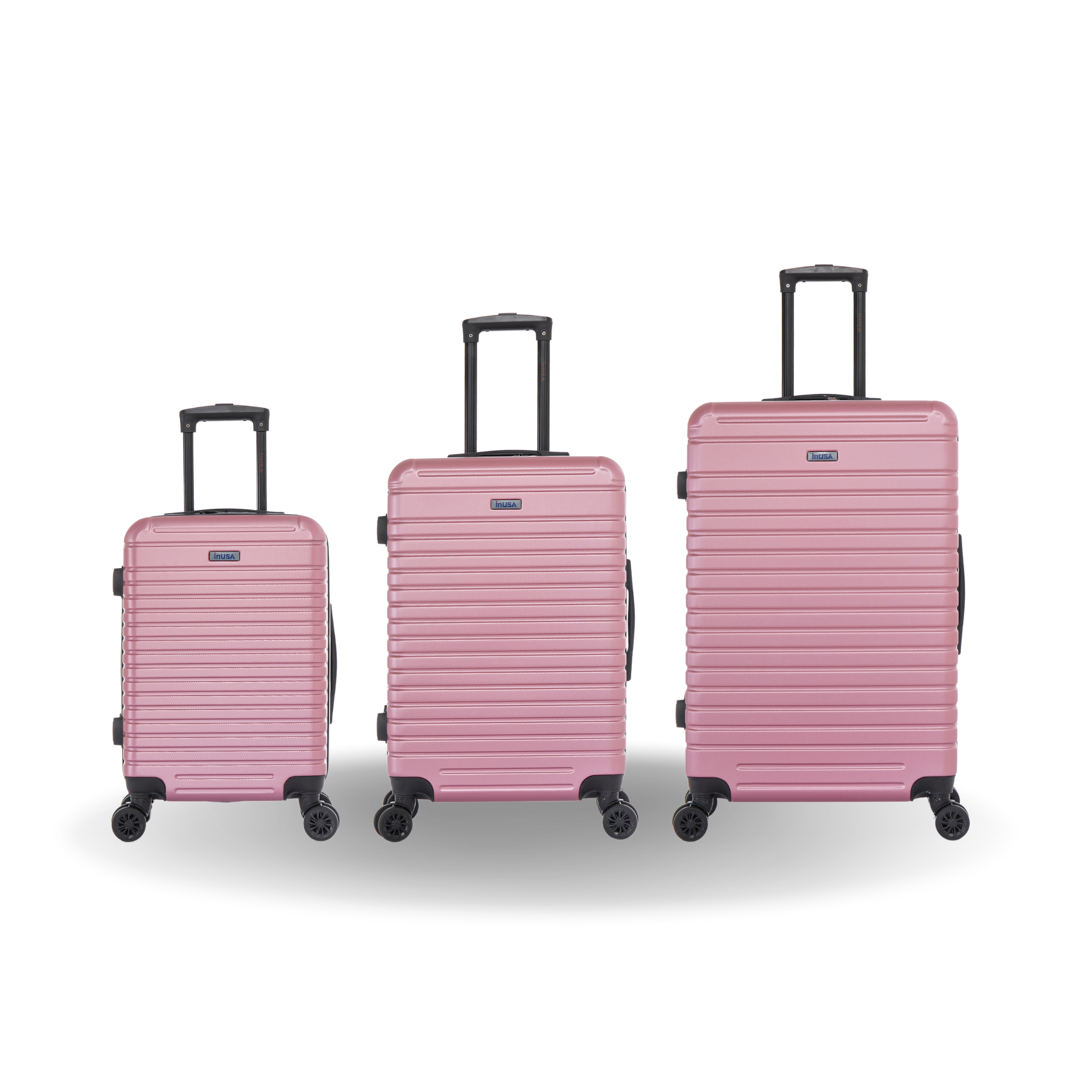 Set of three pink suitcases of different sizes on a white background