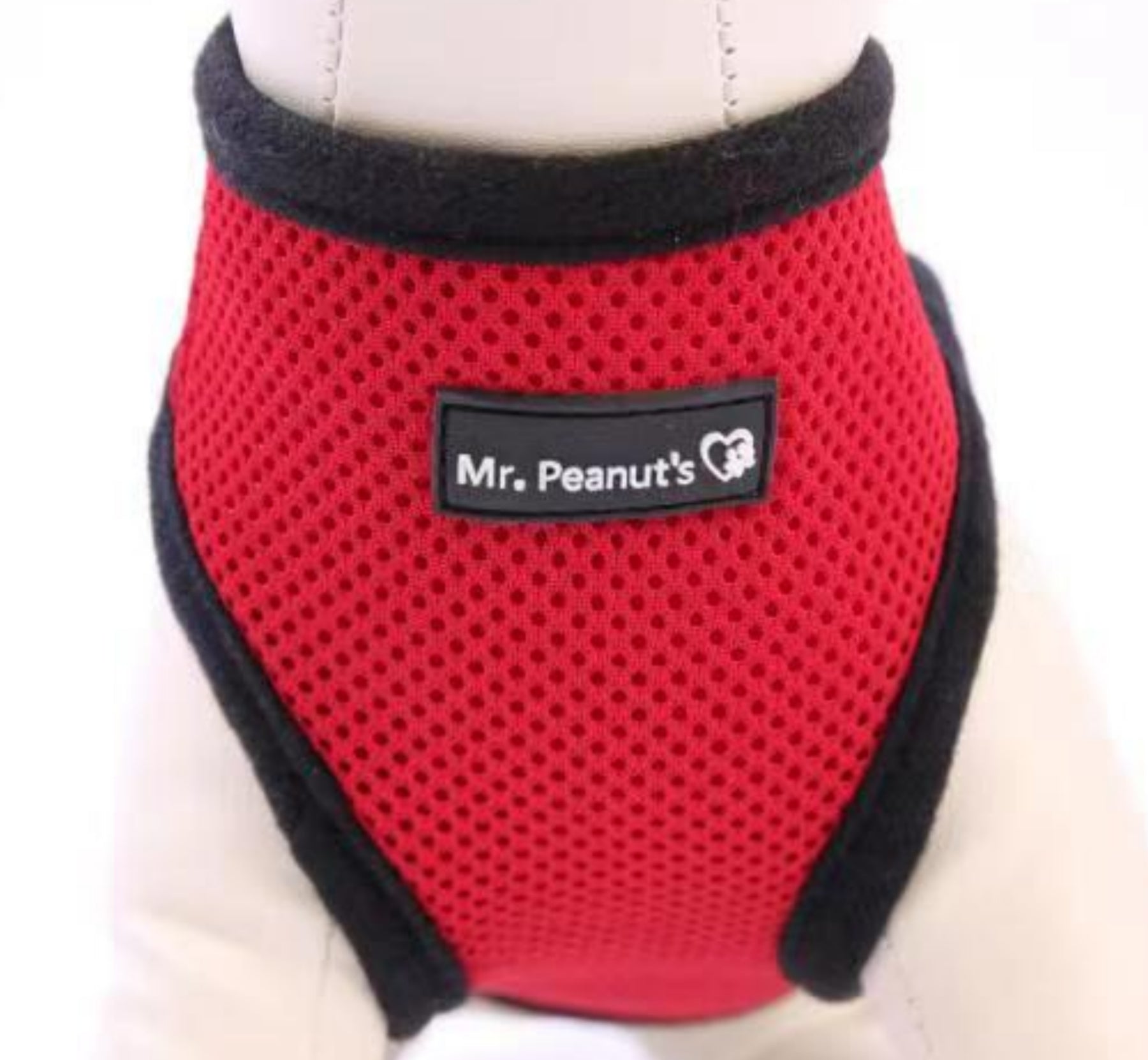 Red pet harness with black trim on a white background