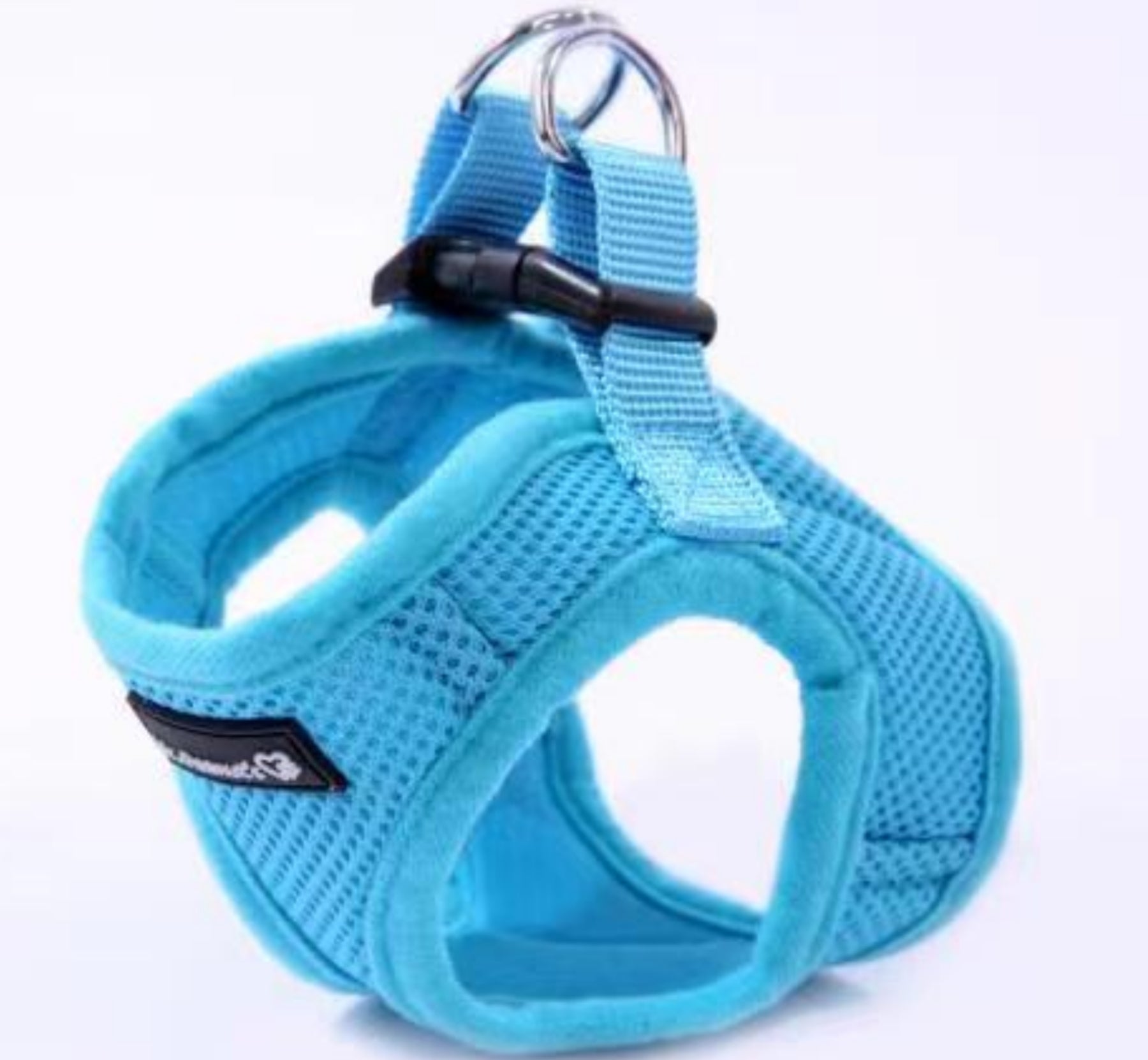 Blue dog harness with a metal clip on a white background