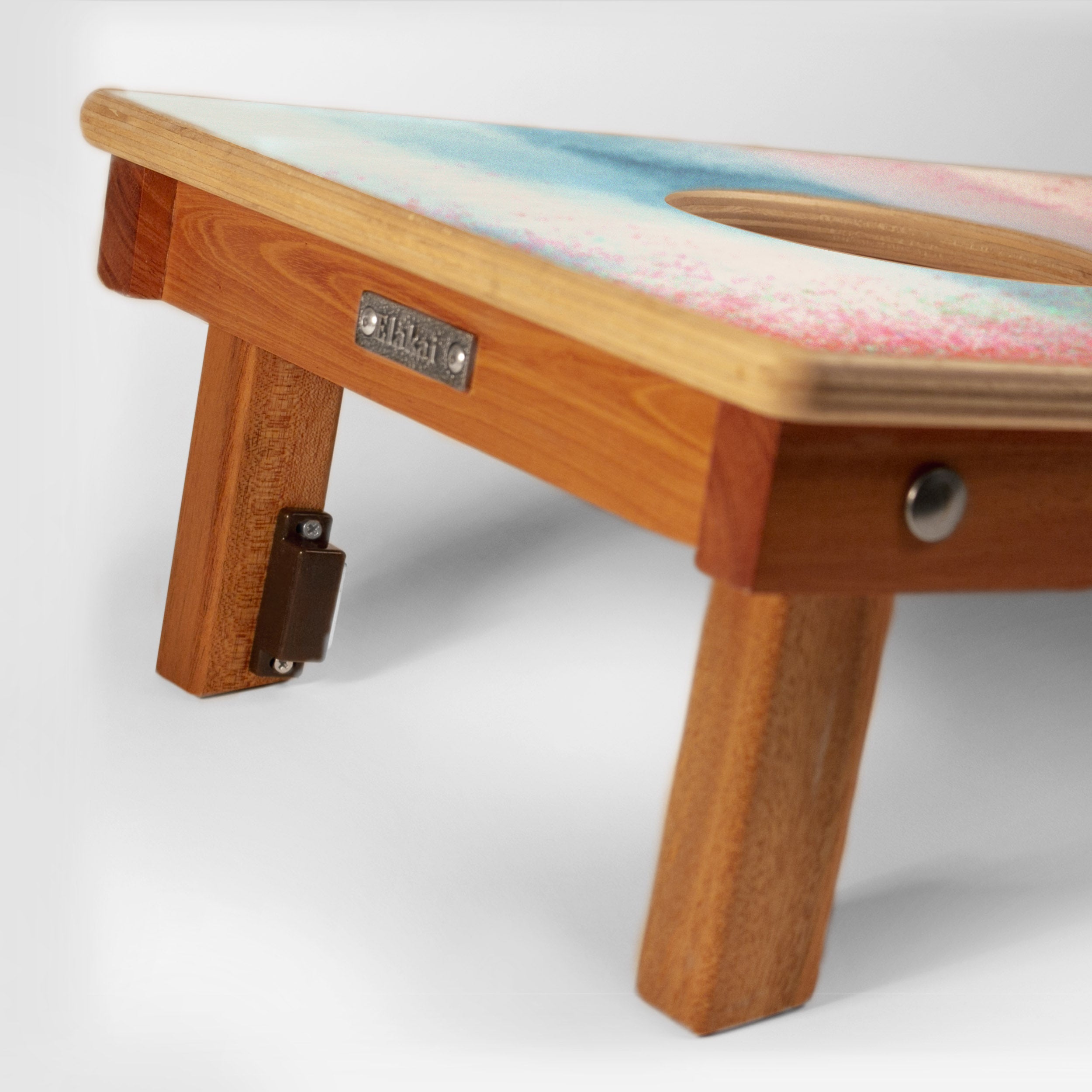 Wooden pet grooming table with colorful cushion on a white background