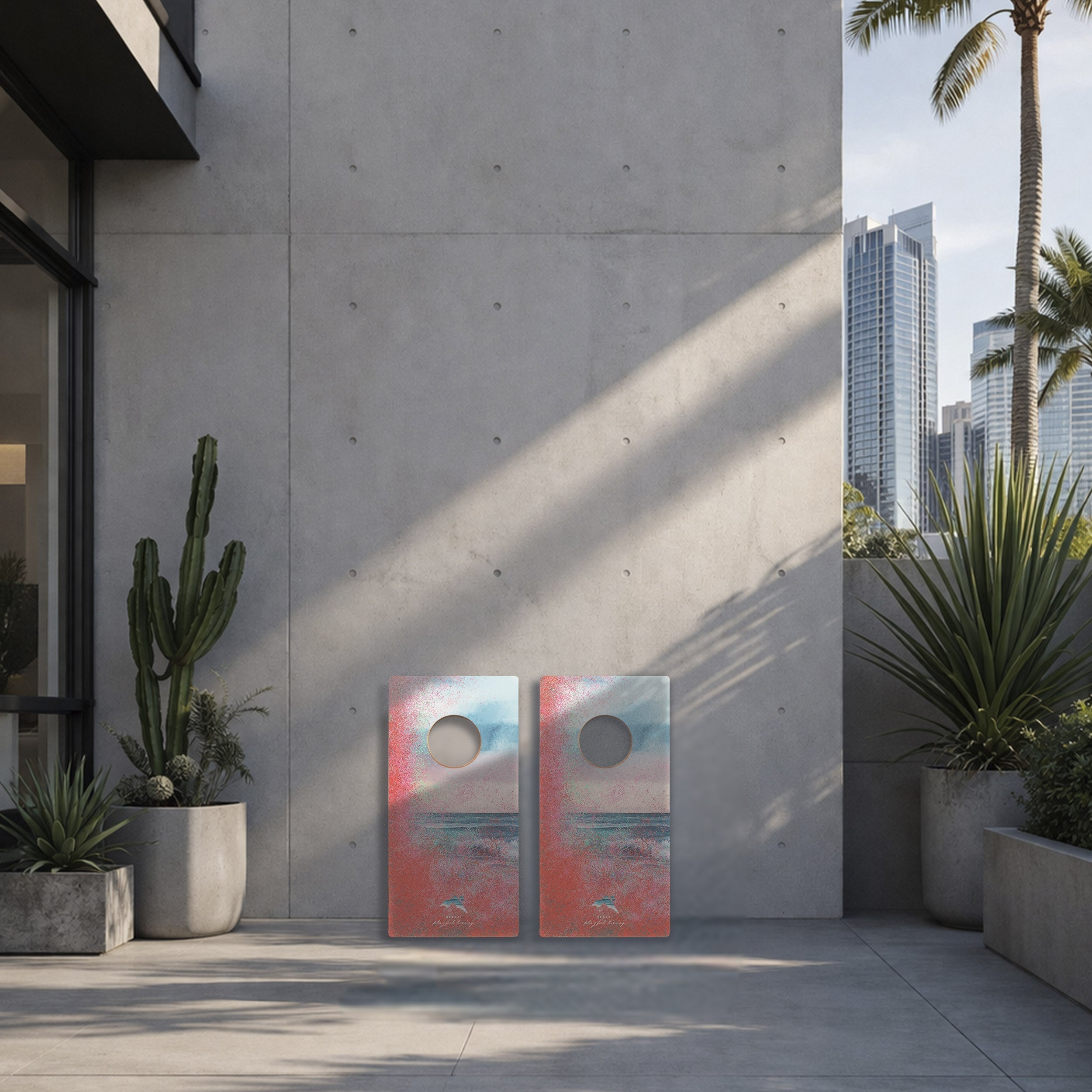 Two abstract paintings leaning against a concrete wall with plants and city skyline in the background.