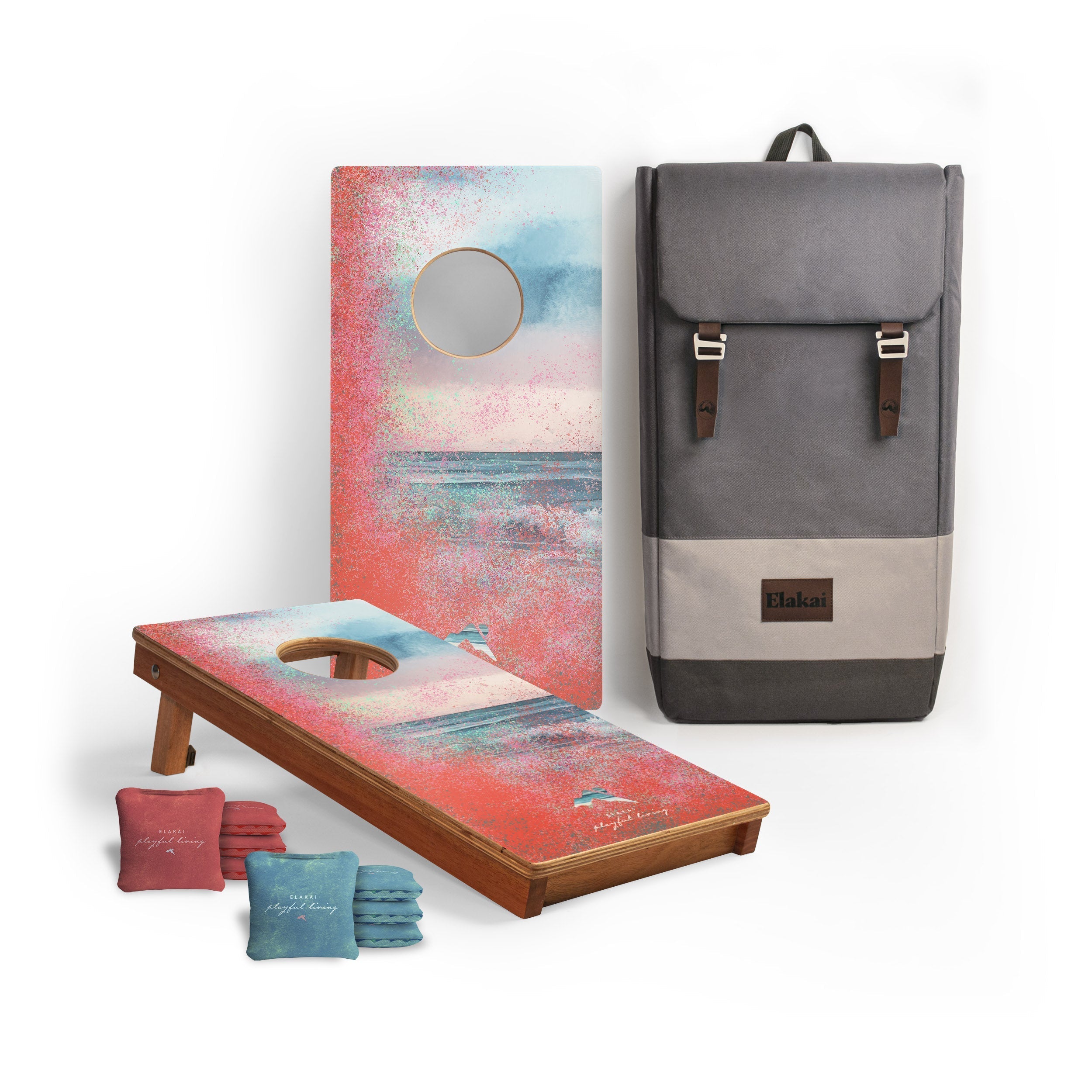Cornhole boards with beach-themed design and a gray backpack on a white background