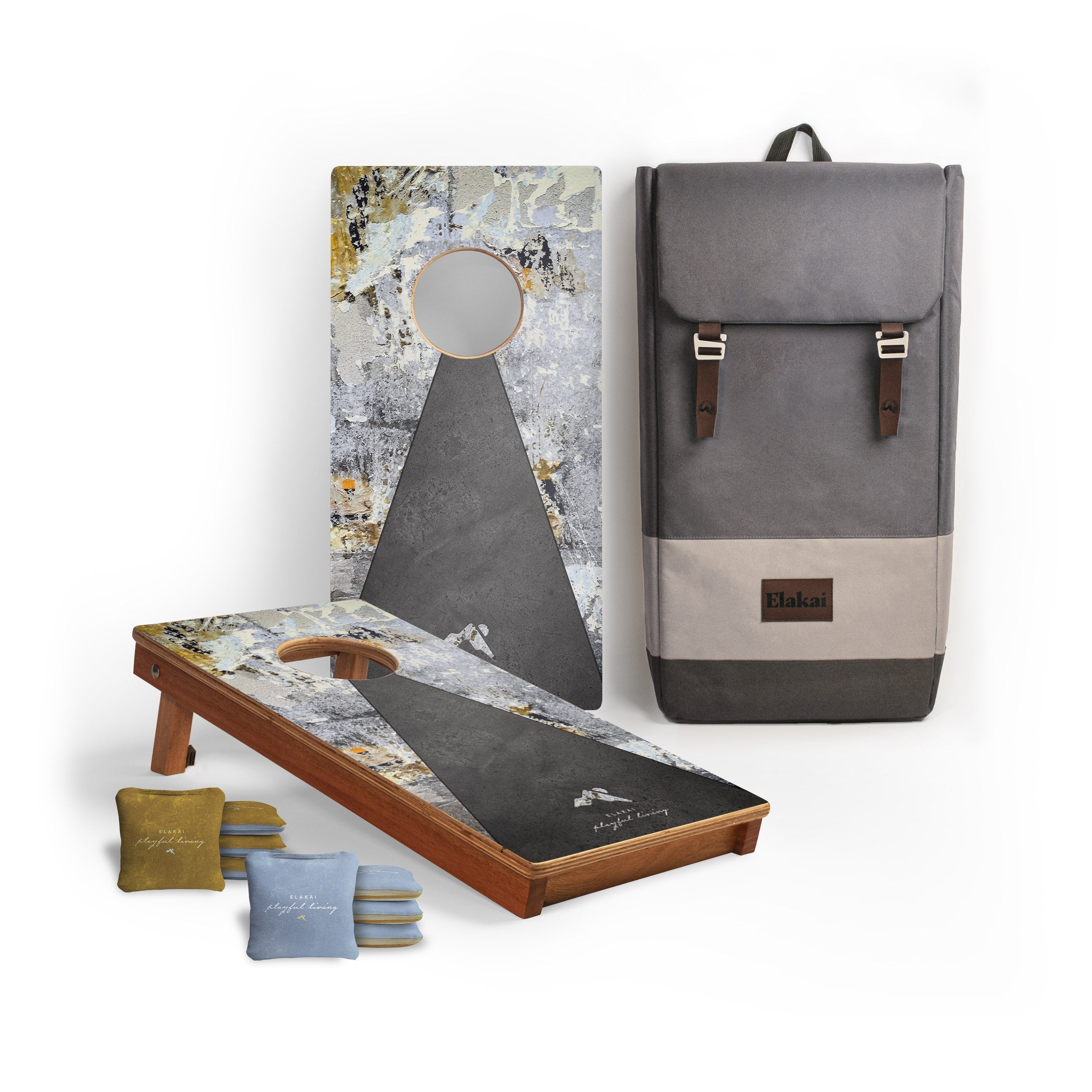 Cornhole board with patterned design and gray backpack on a white background