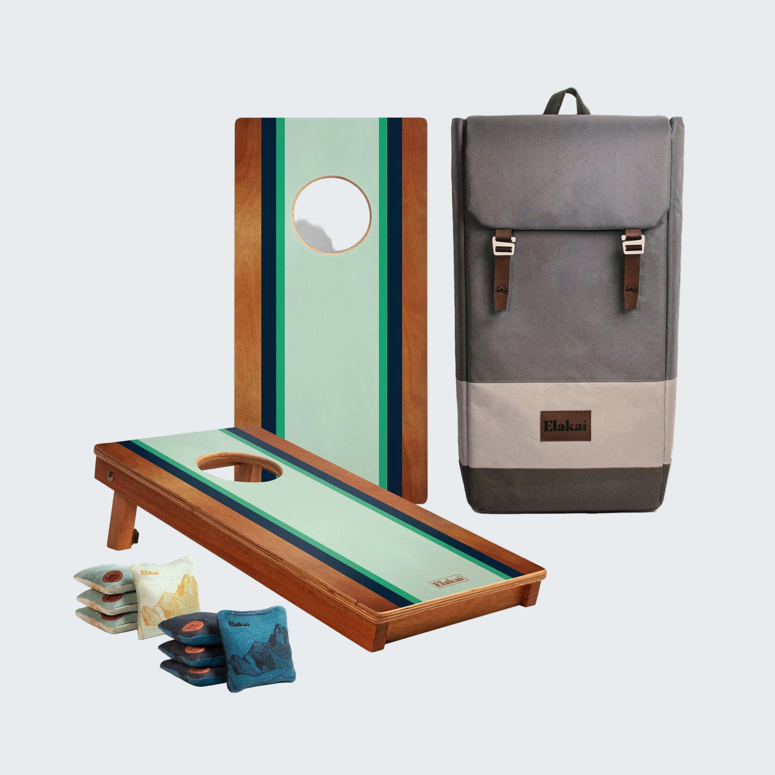 Cornhole boards with striped design and a gray backpack on a white background