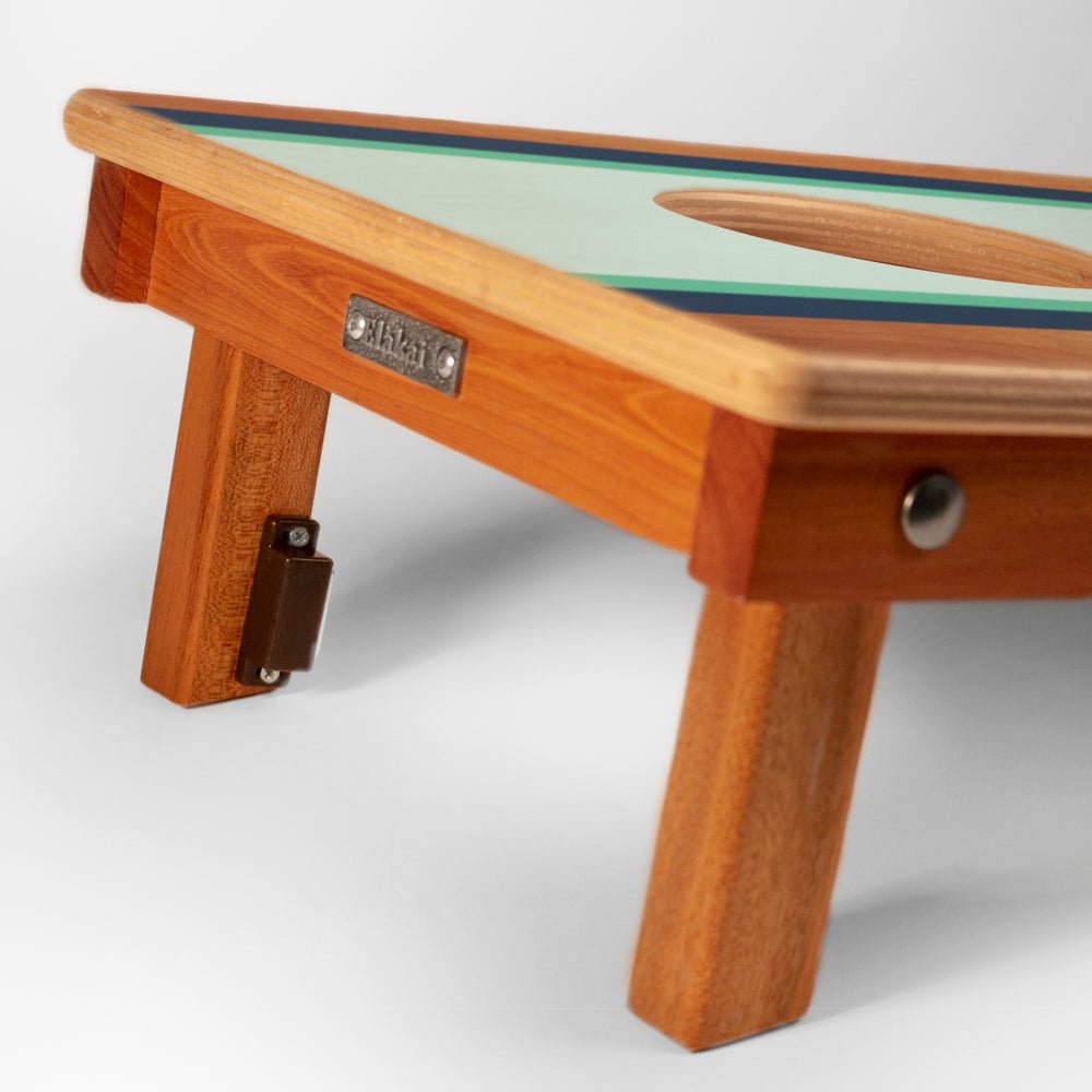 Wooden table with a green top on a white background
