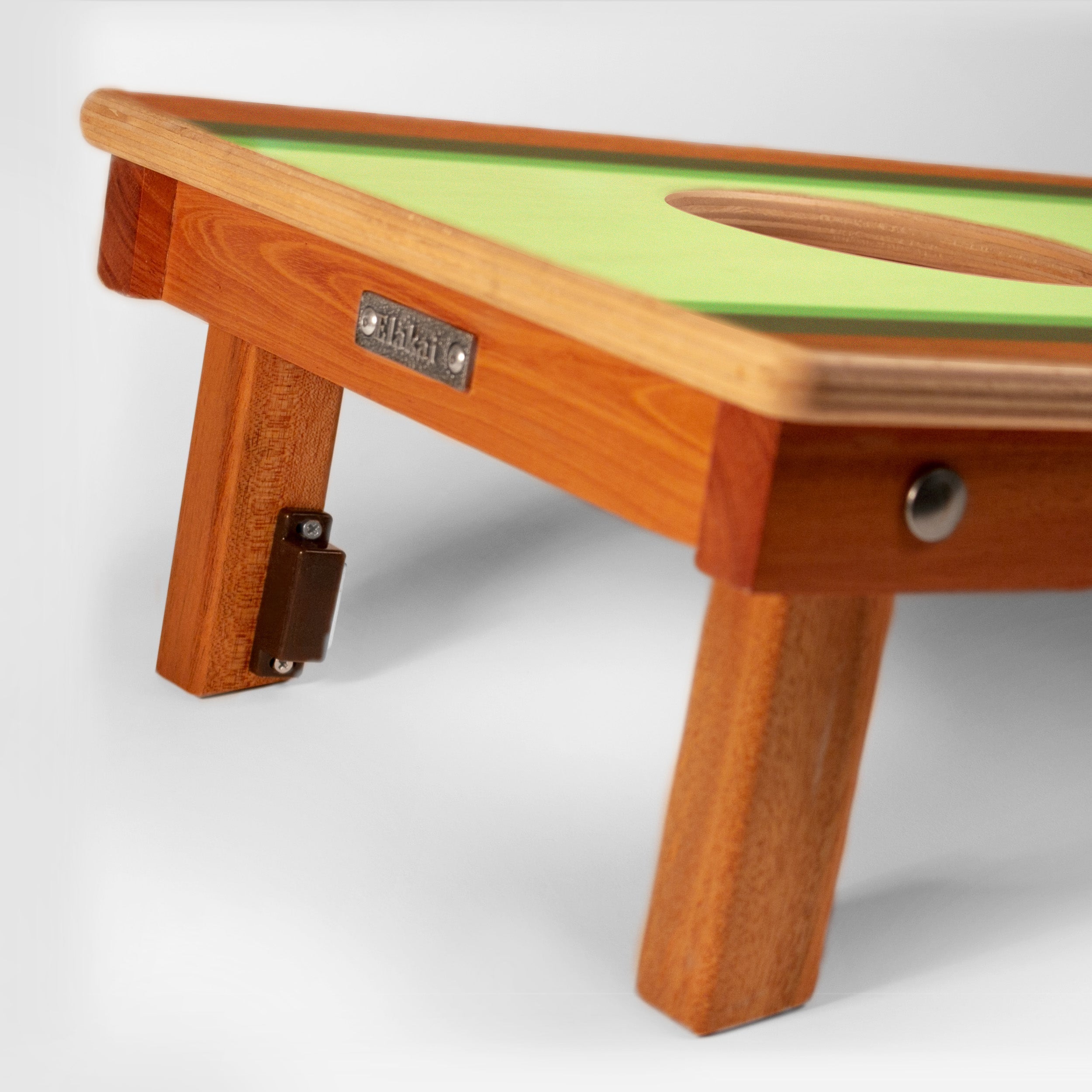 Wooden toy table with green surface on a white background
