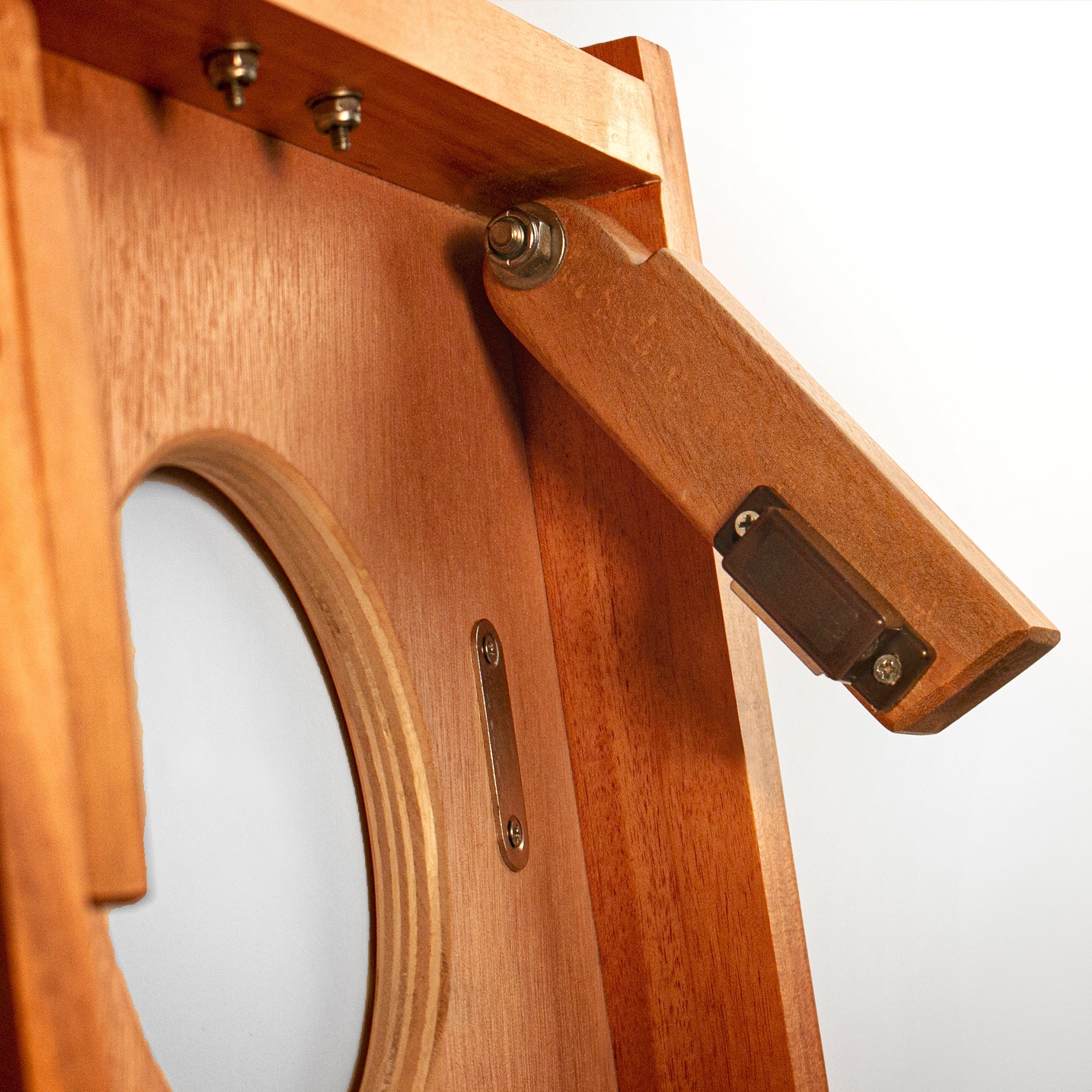 Close-up of a wooden easel with a neutral background