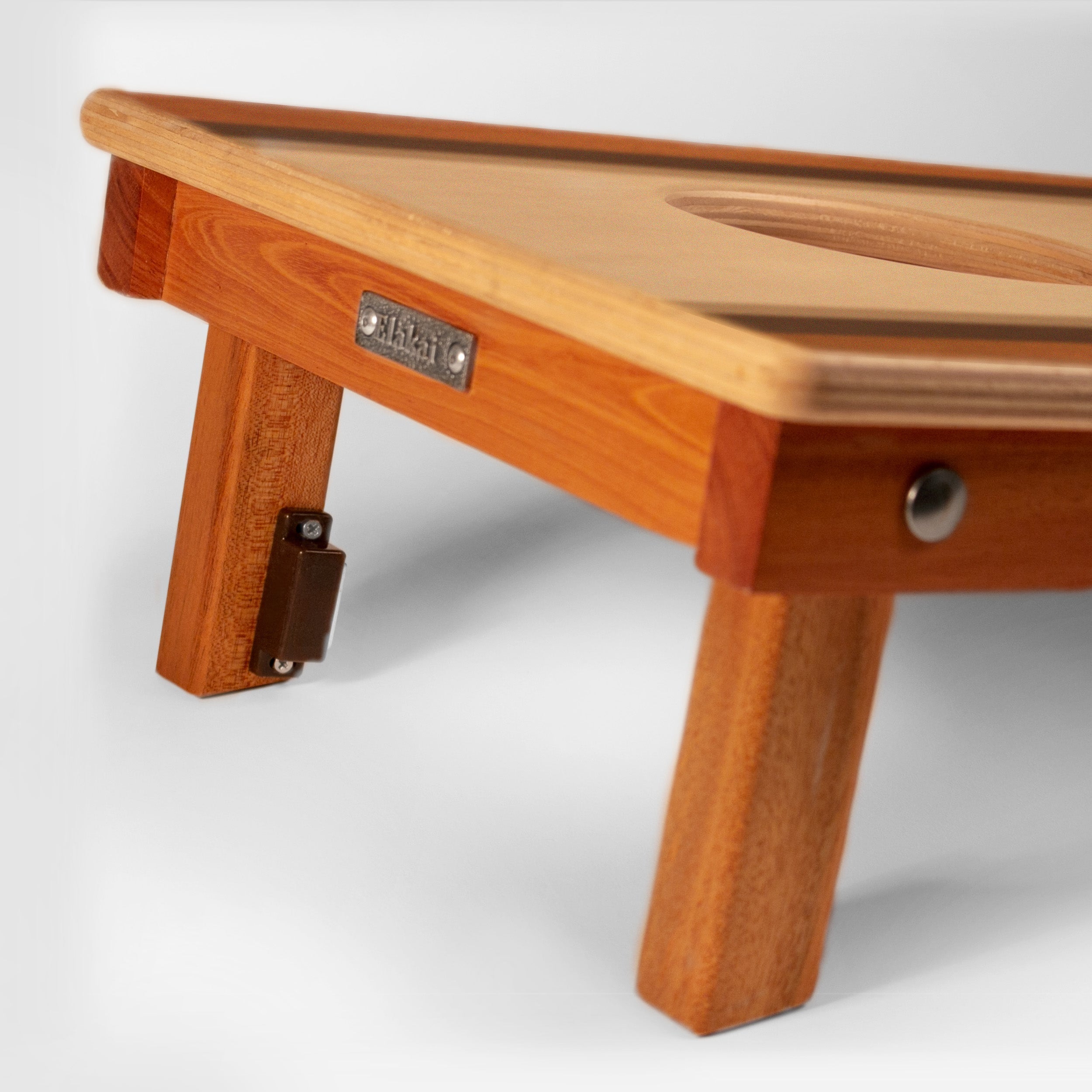 Wooden stool with a visible brand label on a white background