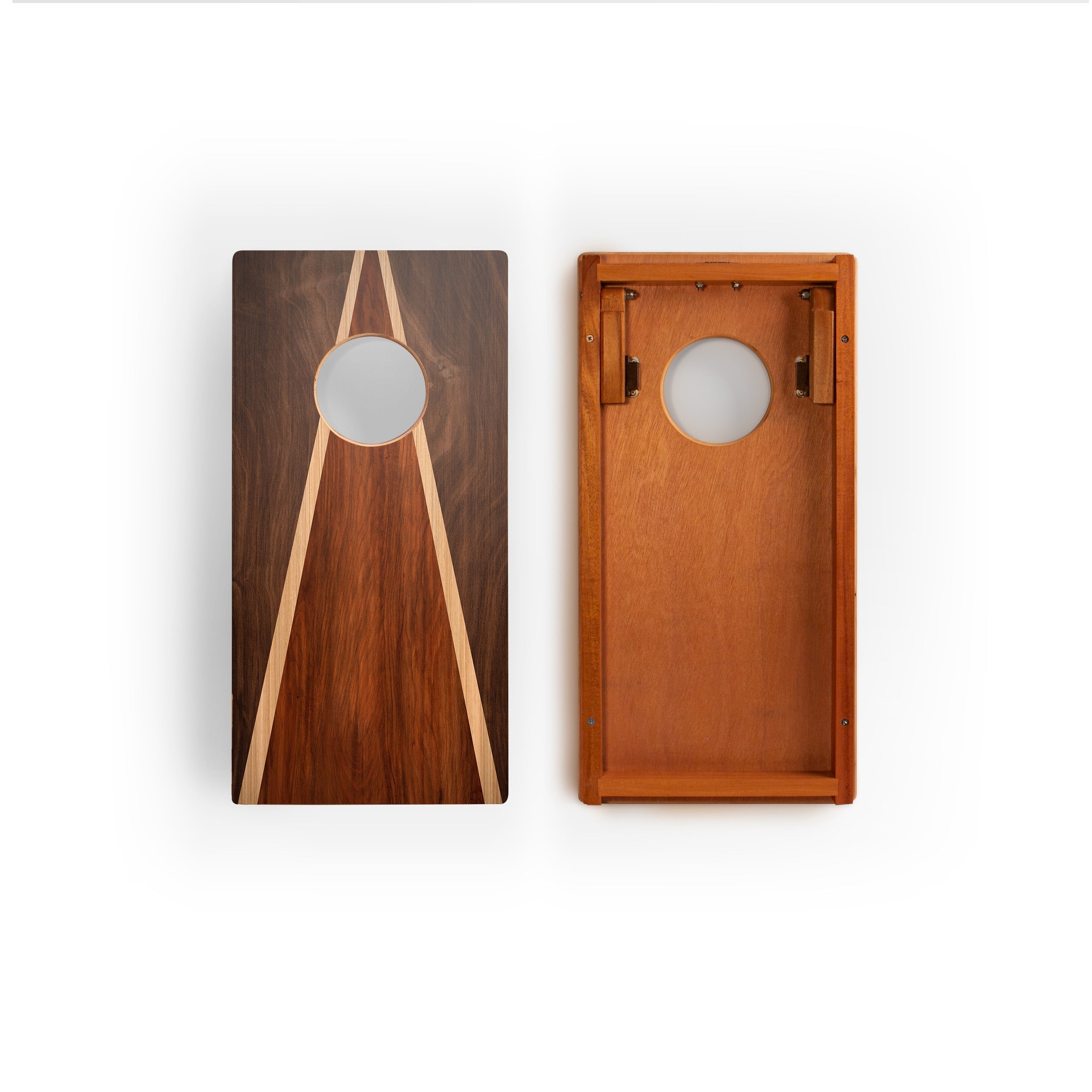 Two wooden cornhole boards shown side by side on a white background, one displaying a dark wood grain design with light wood accents and the other showing the lighter natural wood side with brass hardware.